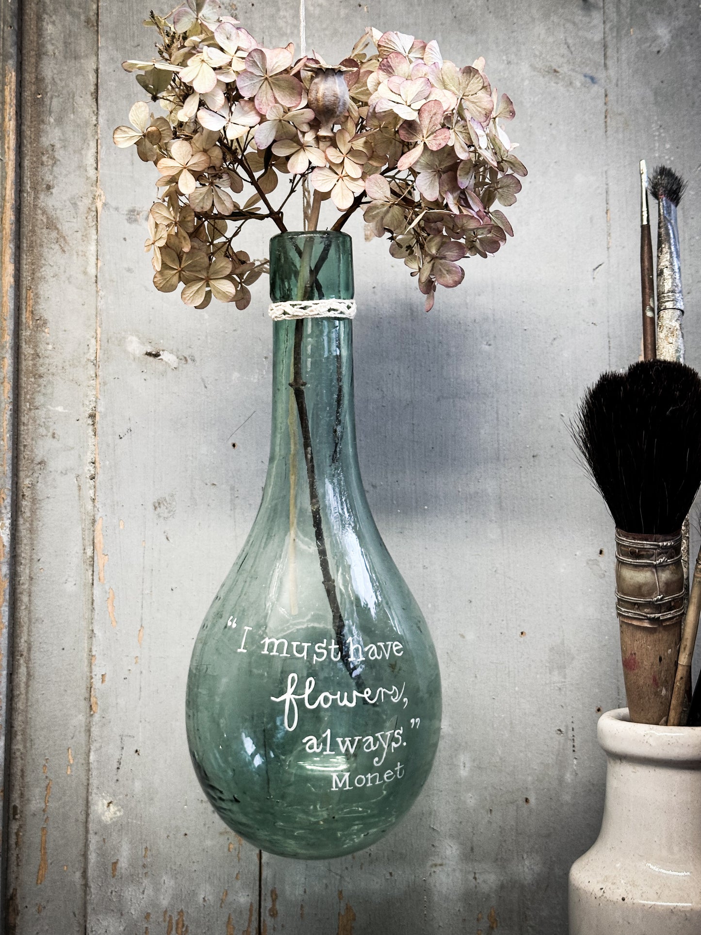 A beautiful antique hanging bulb bottle with a hand painted quote