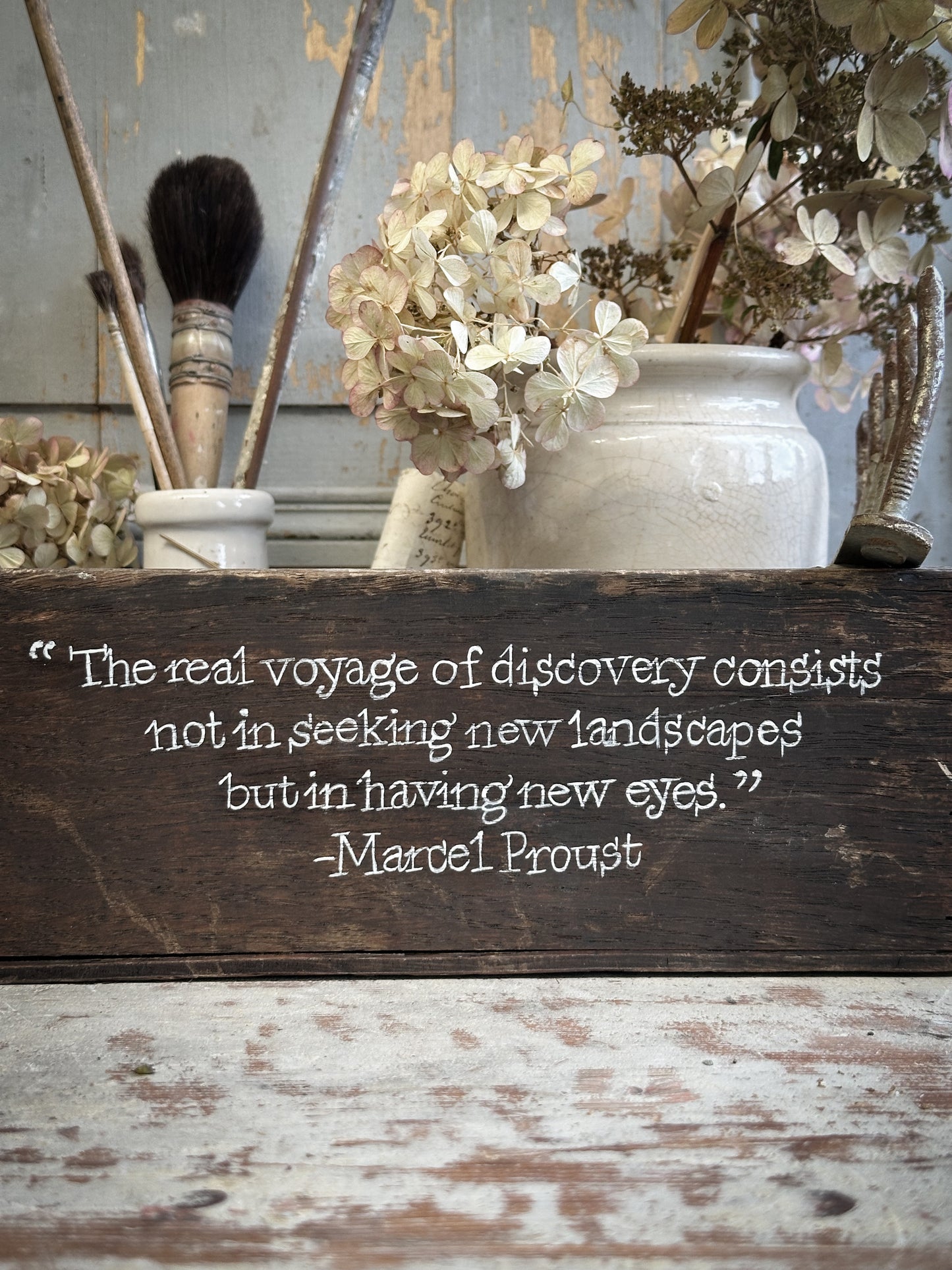 A Vintage Wooden Crate With Hand Painted Quote