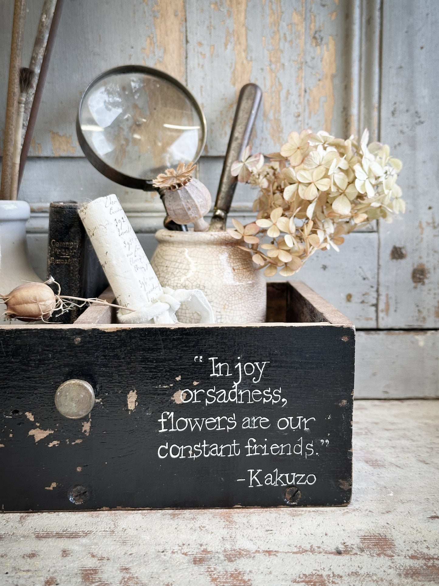 A Vintage Wooden Drawer With Hand Painted Quote