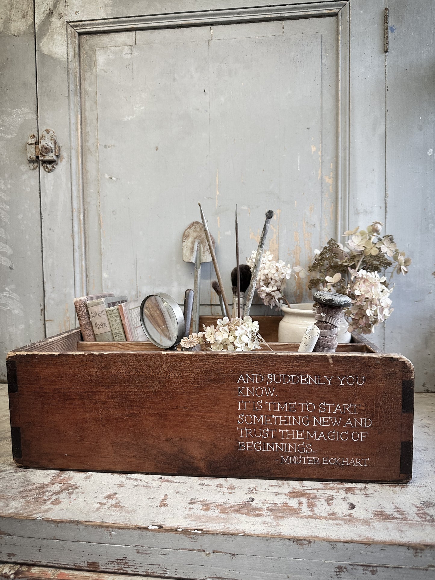A Vintage Wooden Drawer With Hand Painted Quote