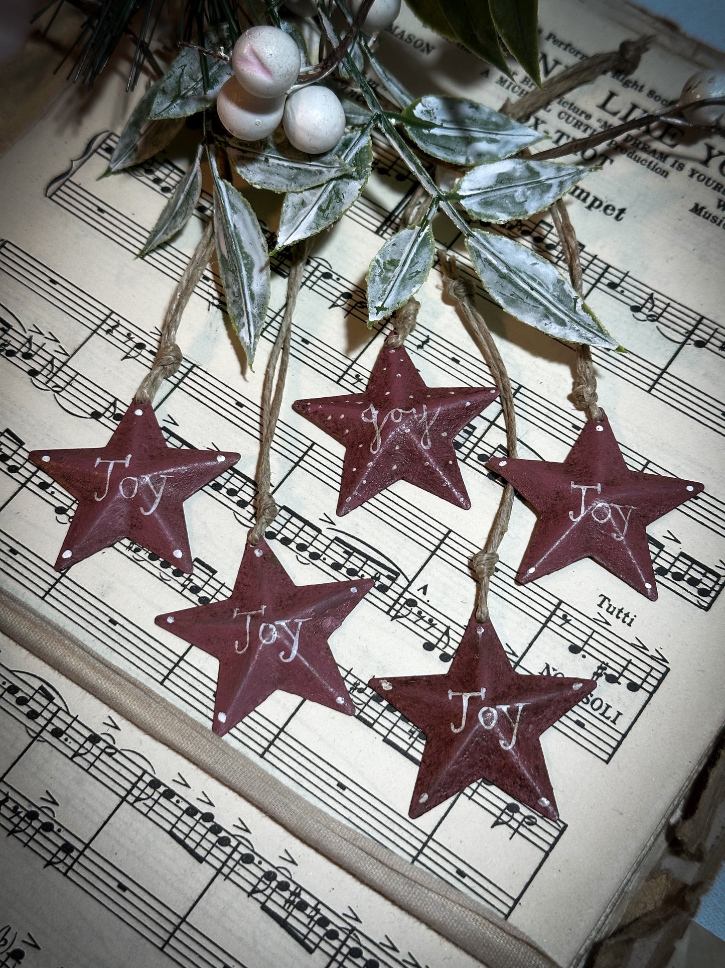 A mini tin barn star pink decoration hand painted with “Joy”