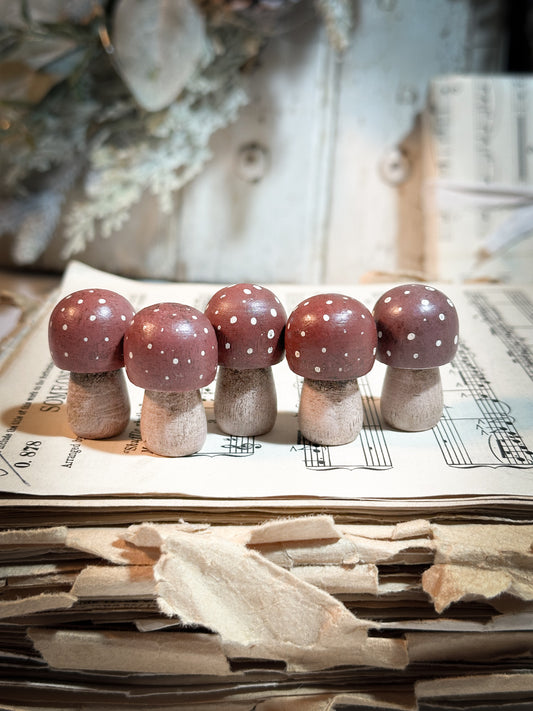 A wooden hand painted Christmas village toadstool