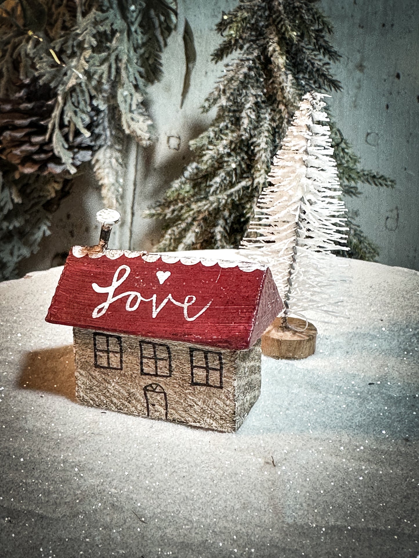 A pretty vintage German Erzgebirge Putz wooden log cabin painted with a Christmas quote