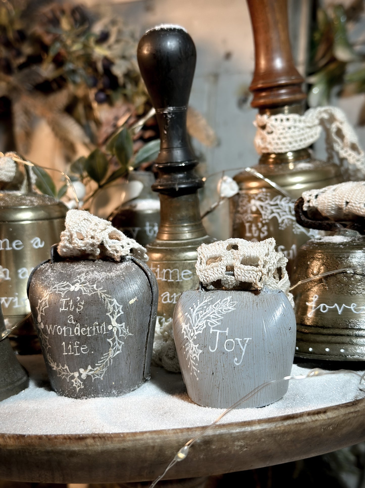 A vintage painted cow bell with a hand painted quote