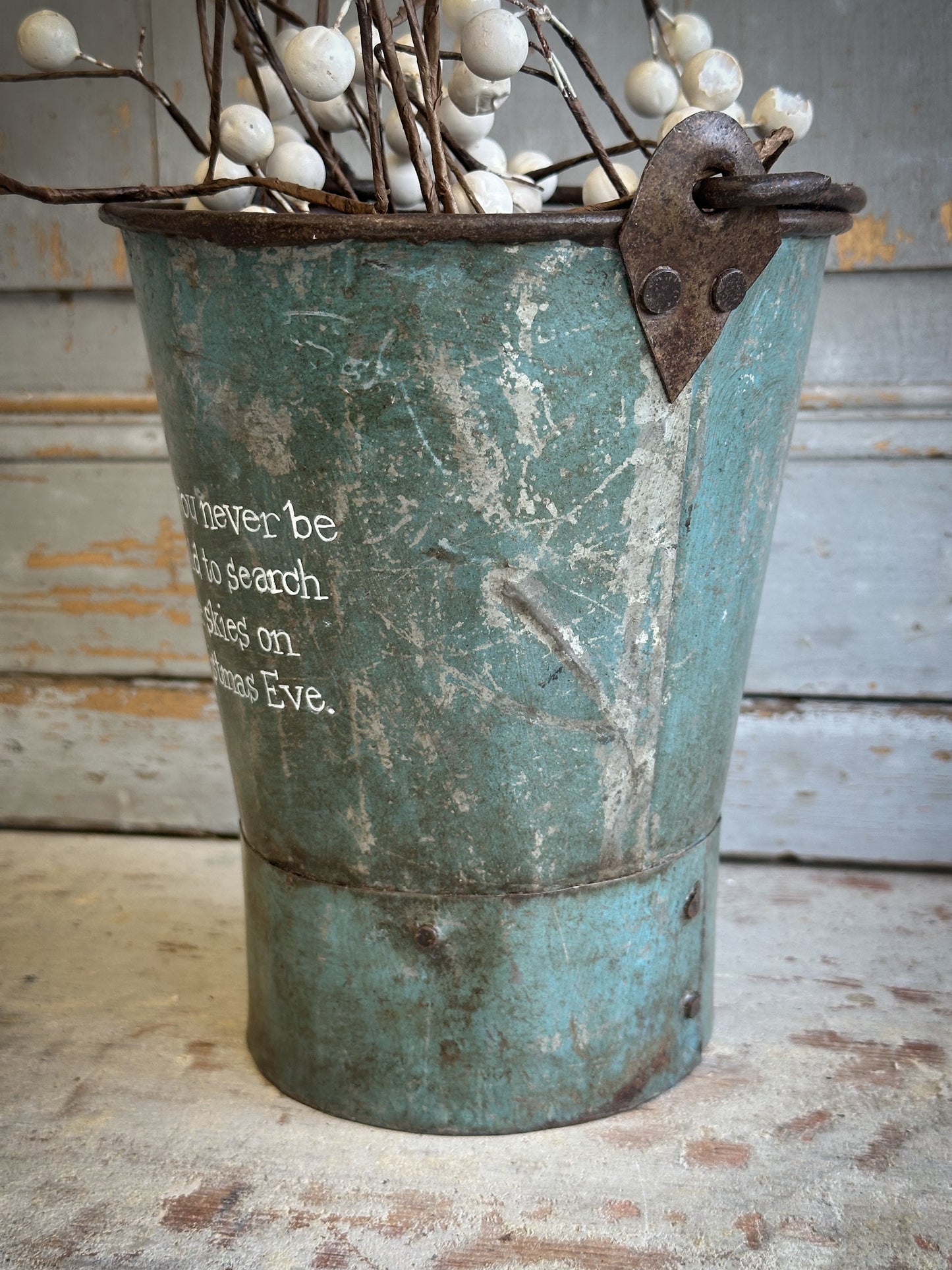 A Recycled Metal Mini Christmas Tree Bucket With A Hand Painted Quote