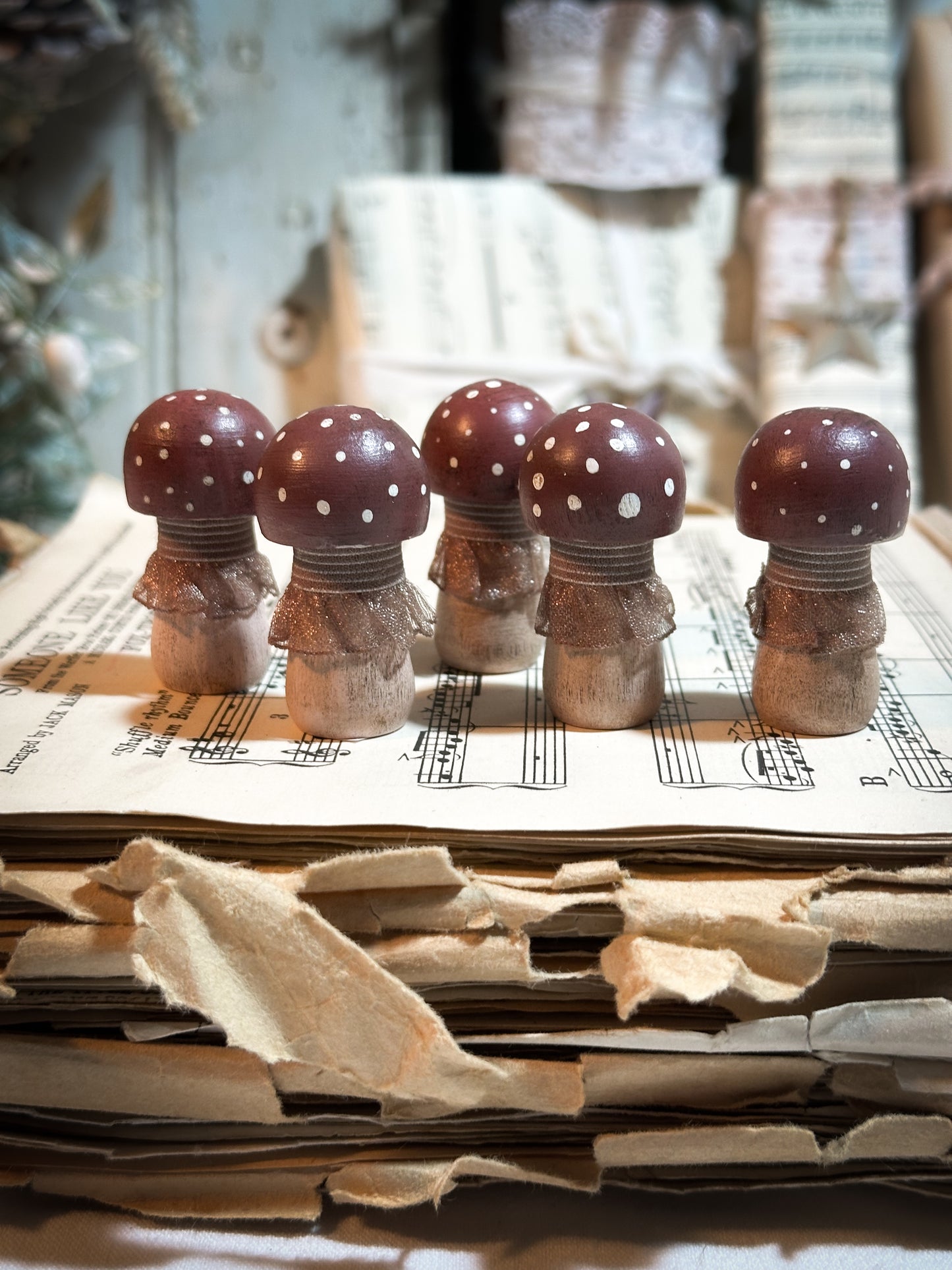 A wooden hand painted and trimmed Christmas village toadstool