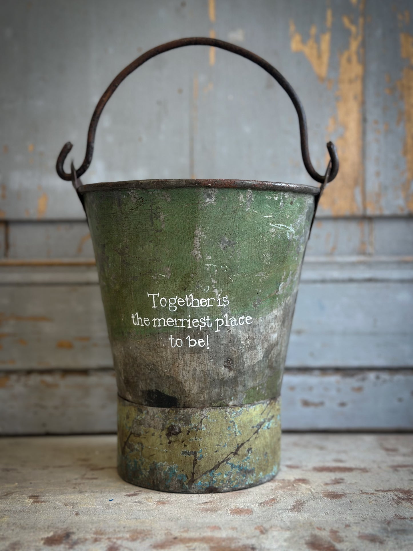 A Recycled Metal Mini Christmas Tree Bucket With A Hand Painted Quote