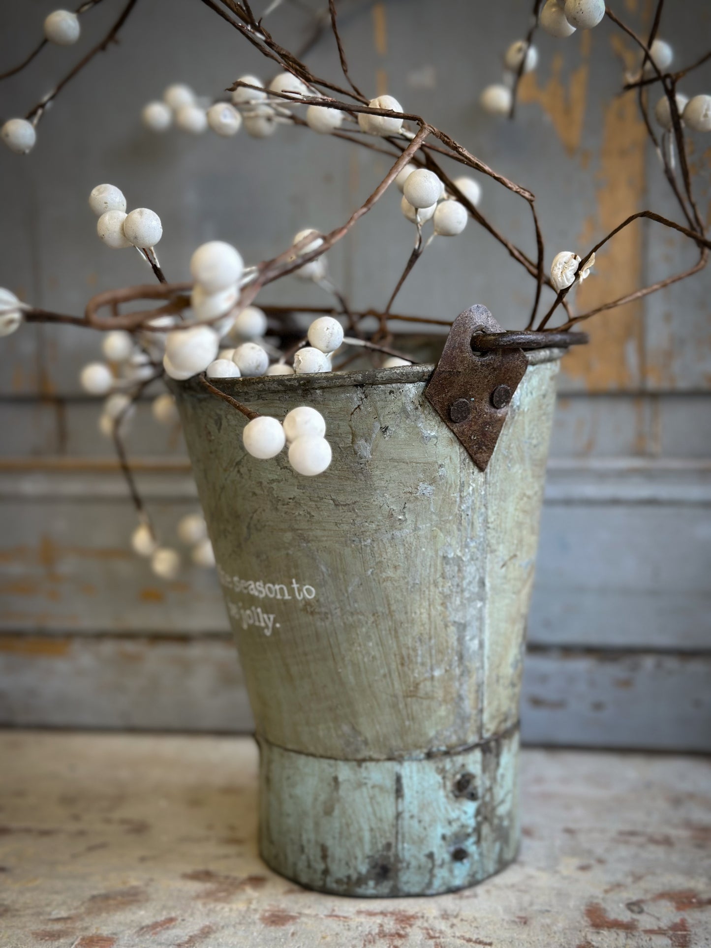A Recycled Metal Mini Christmas Tree Bucket With A Hand Painted Quote