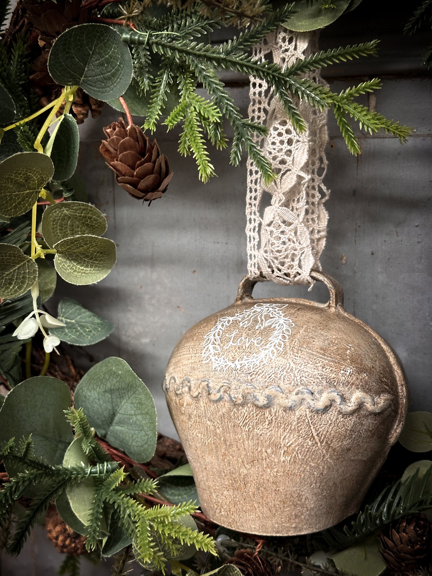 A Large Vintage Painted Cow Bell With a Hand Painted Quote