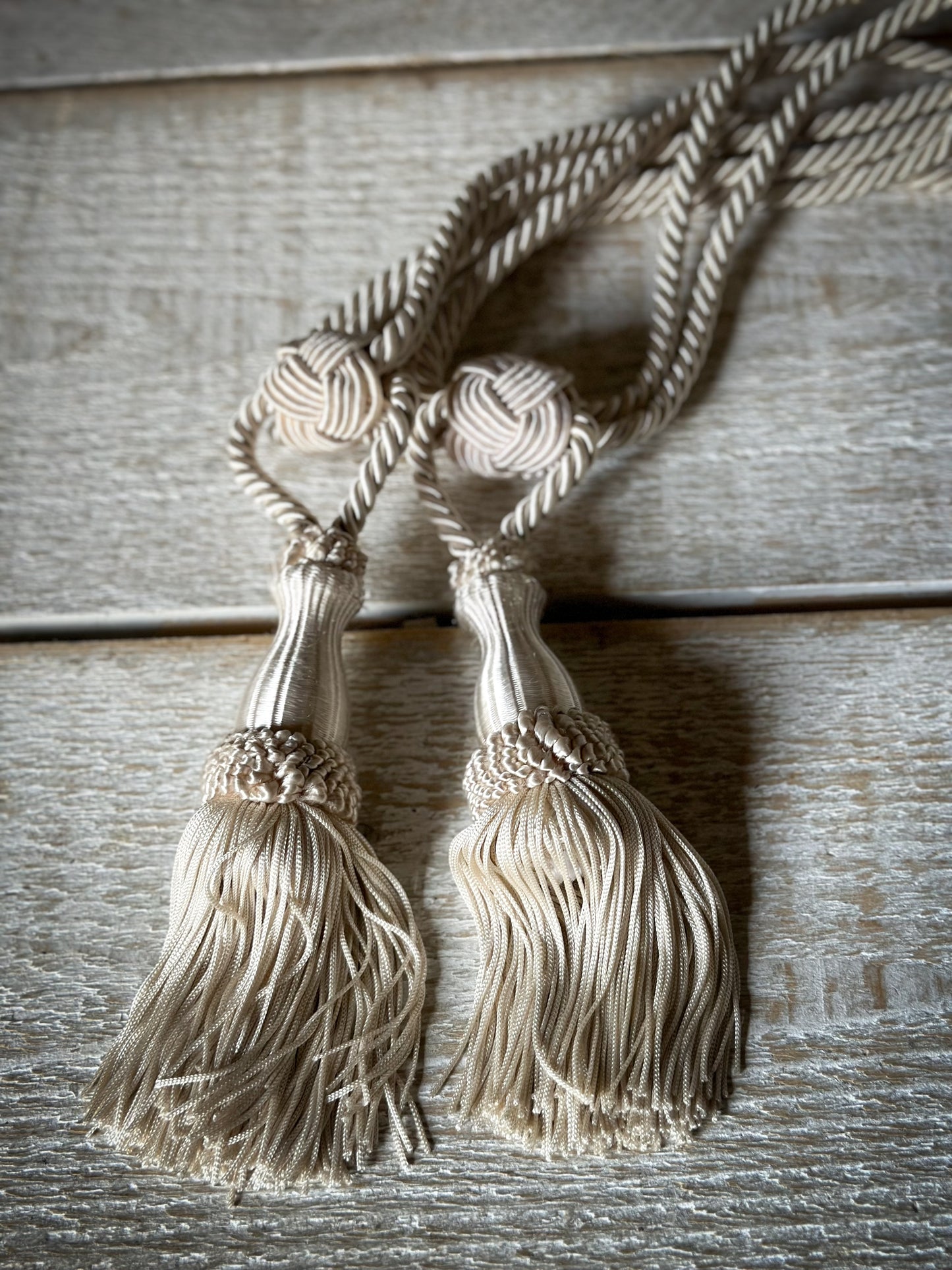 A pair of pretty vintage ivory curtain tie backs