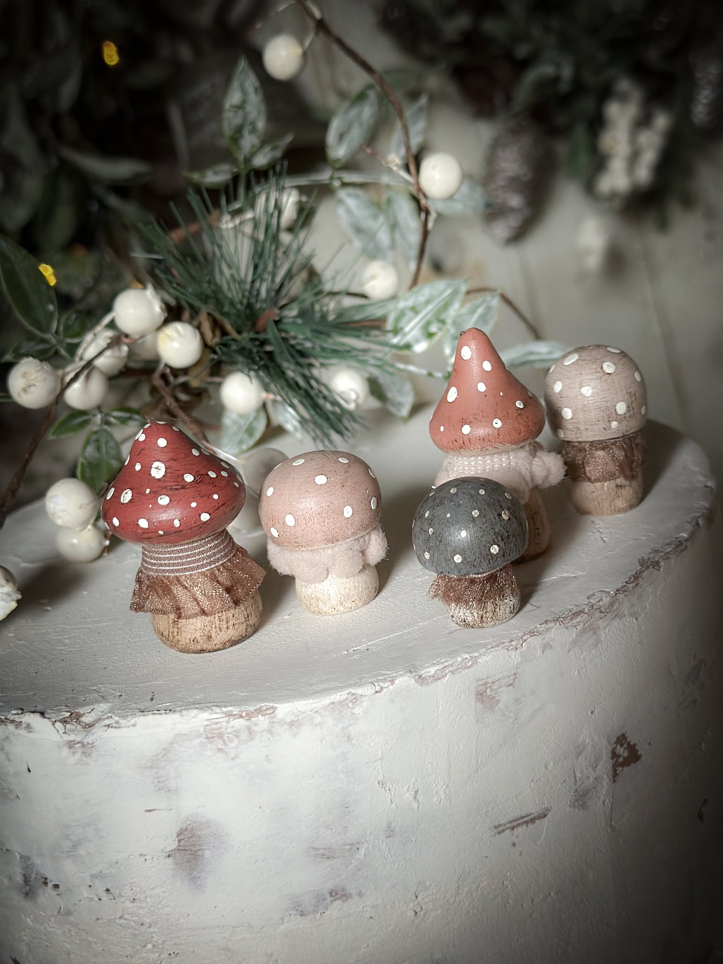 A set of five wooden hand painted and trimmed Christmas village toadstools