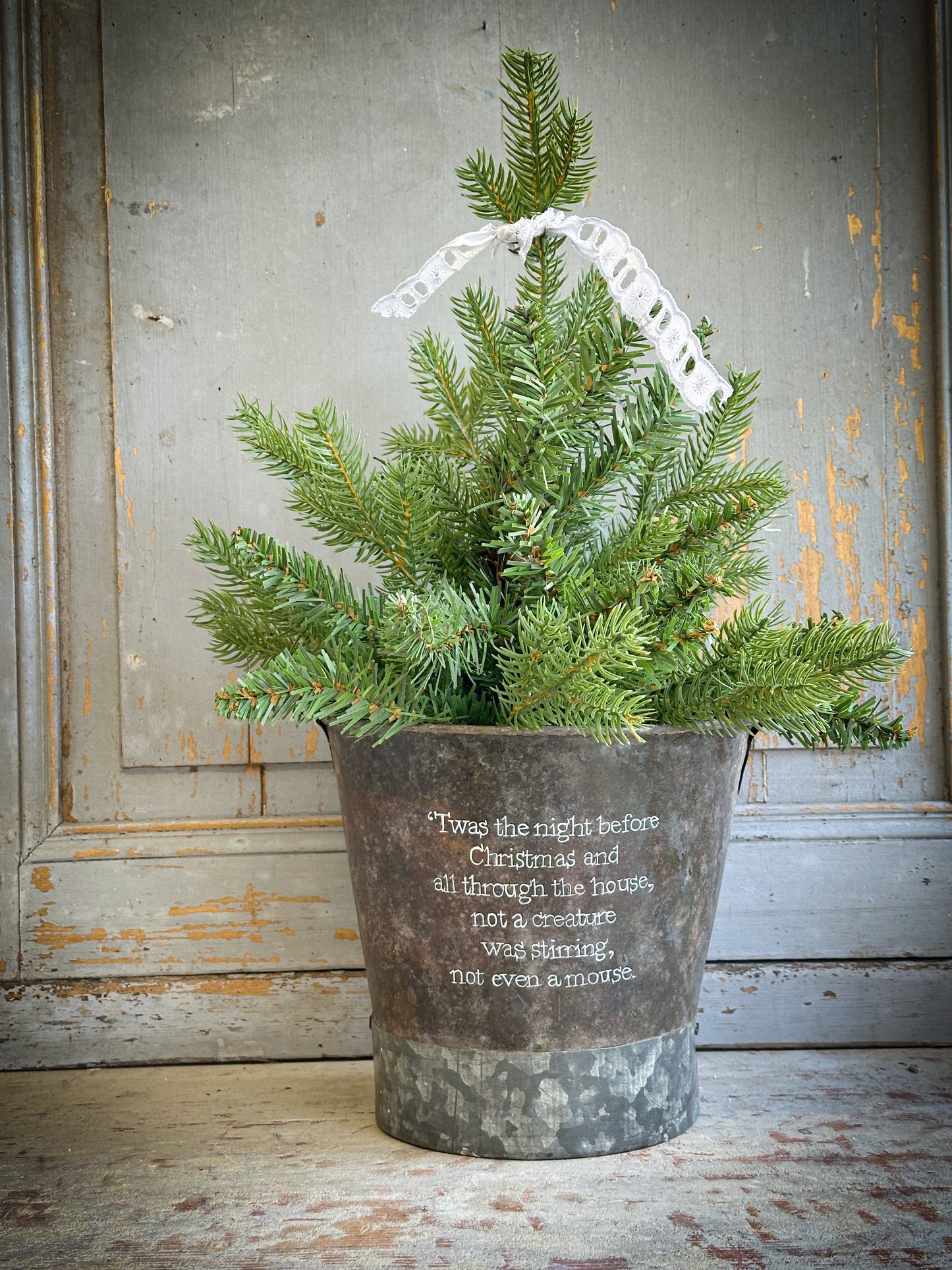 A Recycled Metal Small Christmas Tree Bucket With A Hand Painted Quote