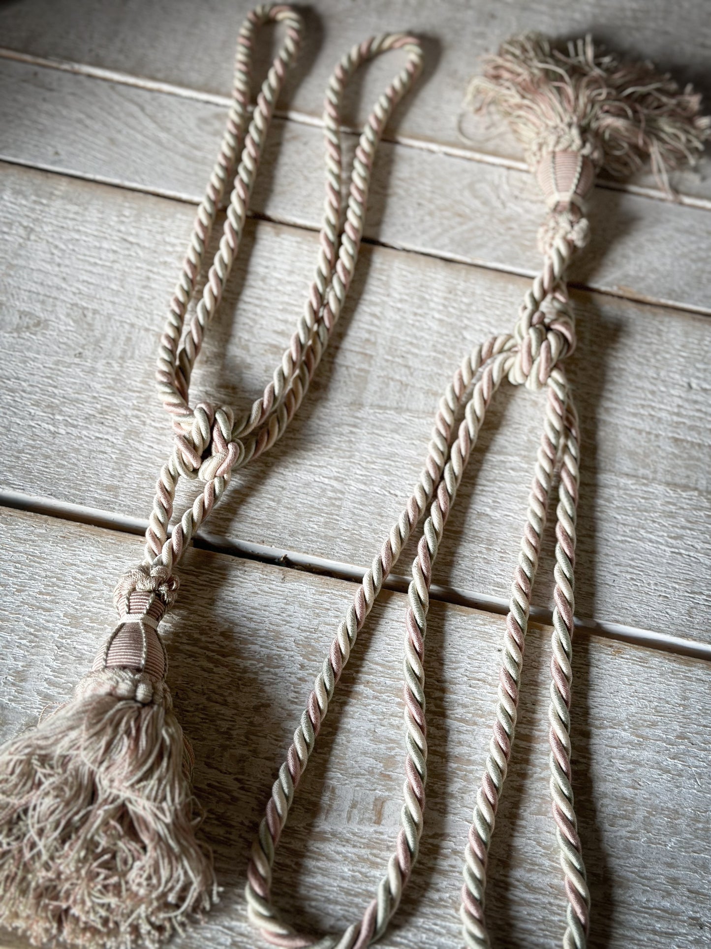 A pair of pretty vintage pastel pink, sage green and ivory curtain tie backs