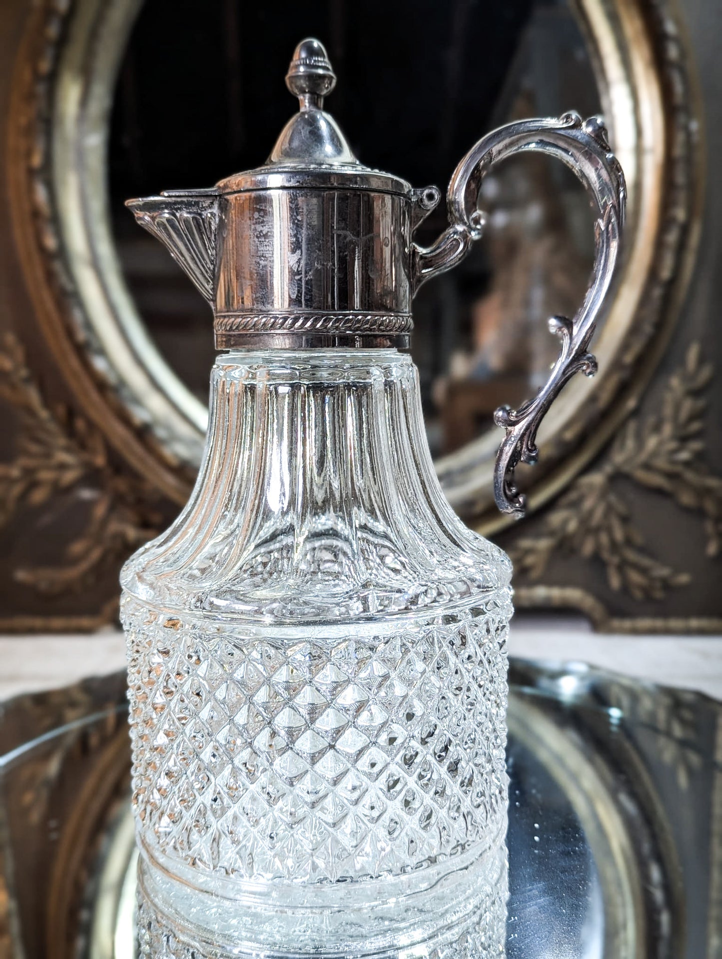 A vintage pressed glass silver plated wine jug