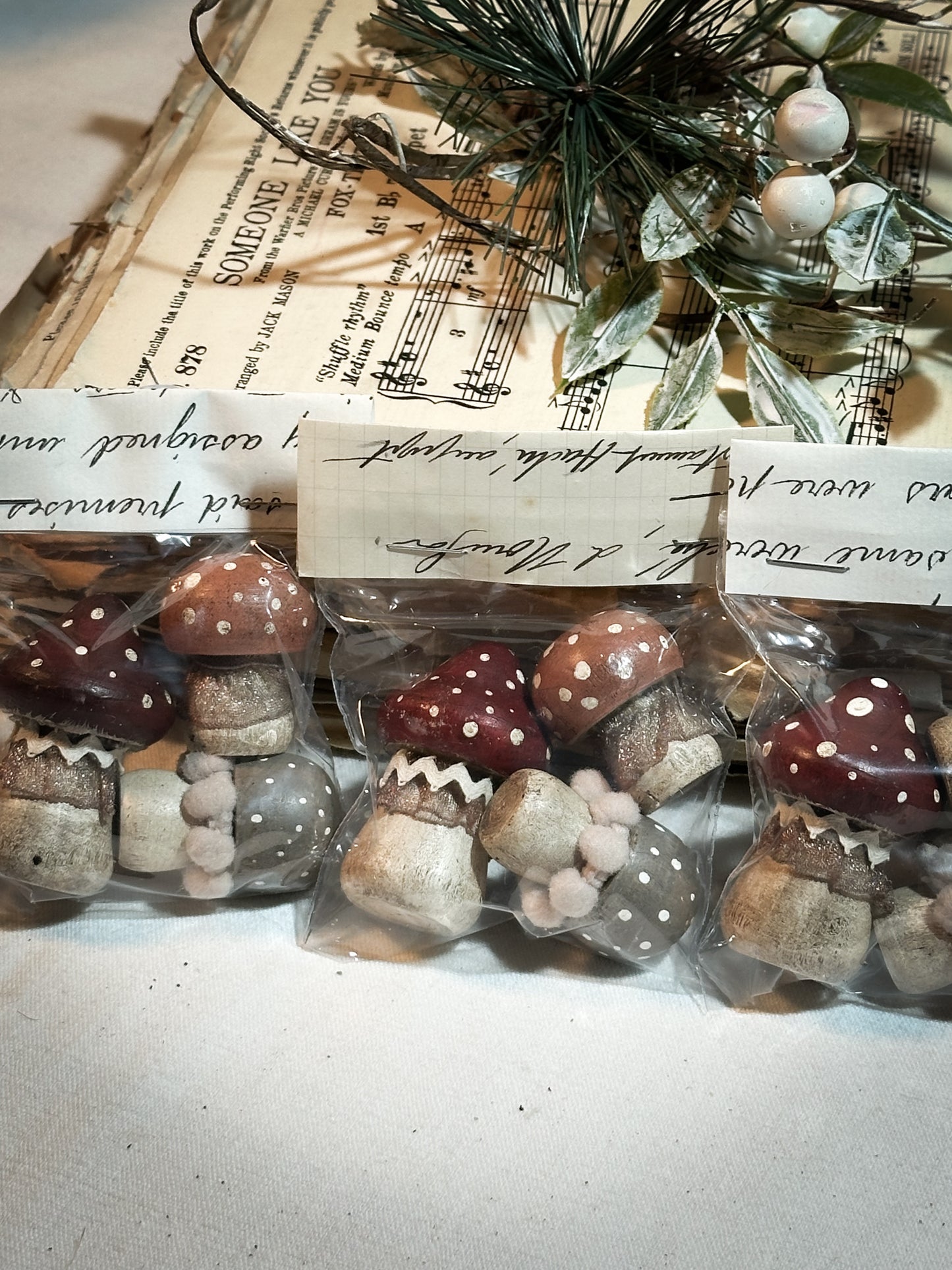 A set of three wooden hand painted and trimmed Christmas village toadstools