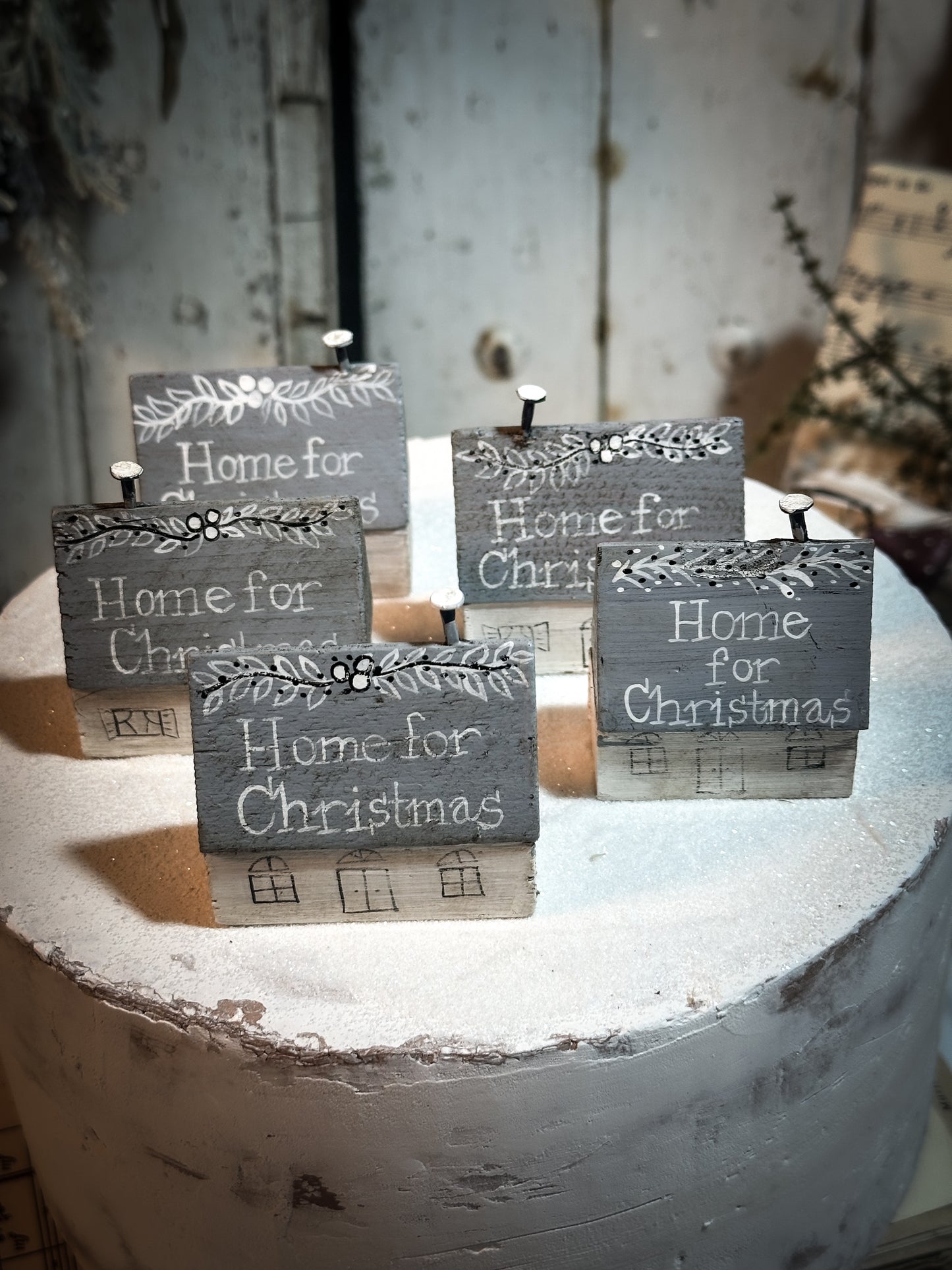 A pretty vintage German Erzgebirge Putz wooden village house painted with a Christmas quote