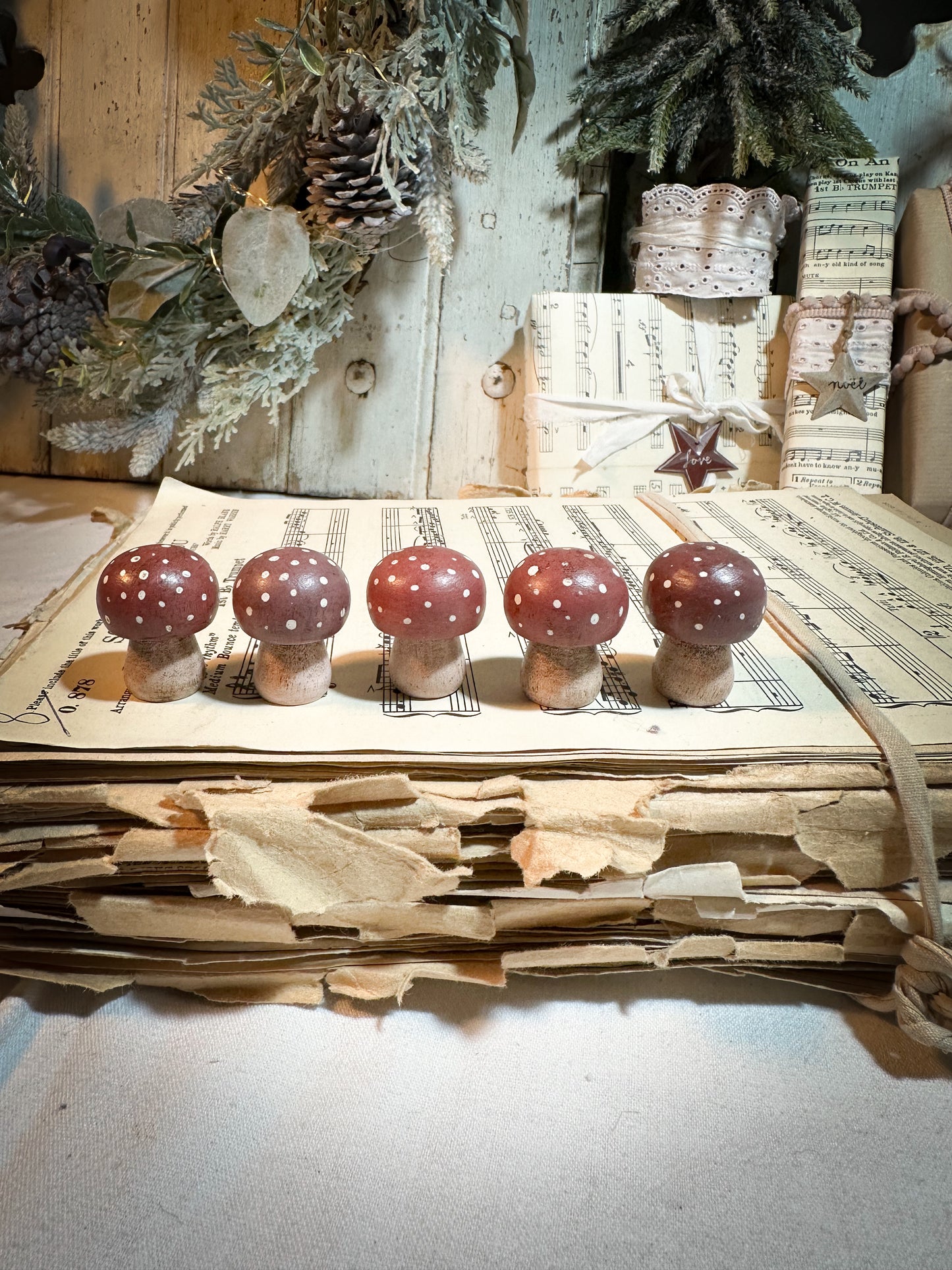 A wooden hand painted Christmas village toadstool