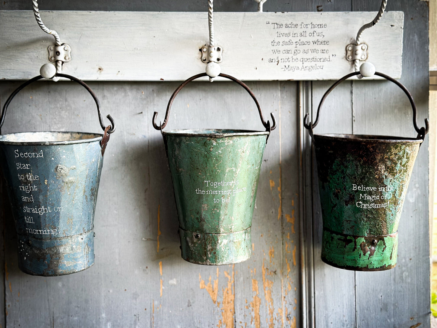 A Recycled Metal Mini Christmas Tree Bucket With A Hand Painted Quote