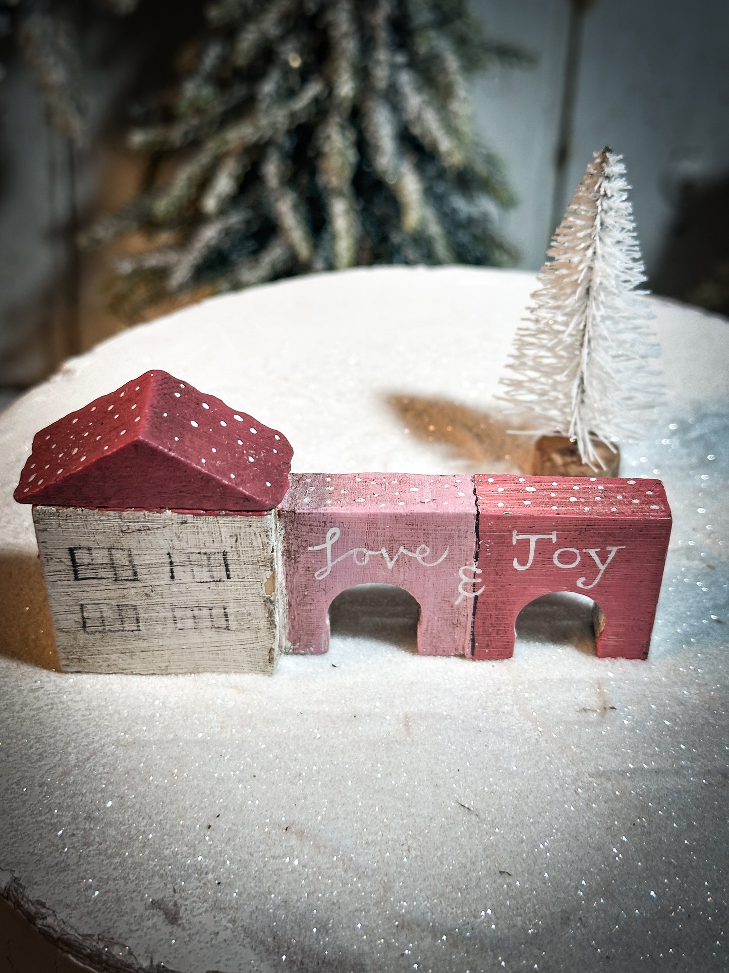 A pretty vintage German Erzgebirge Putz wooden village house painted with a Christmas quote