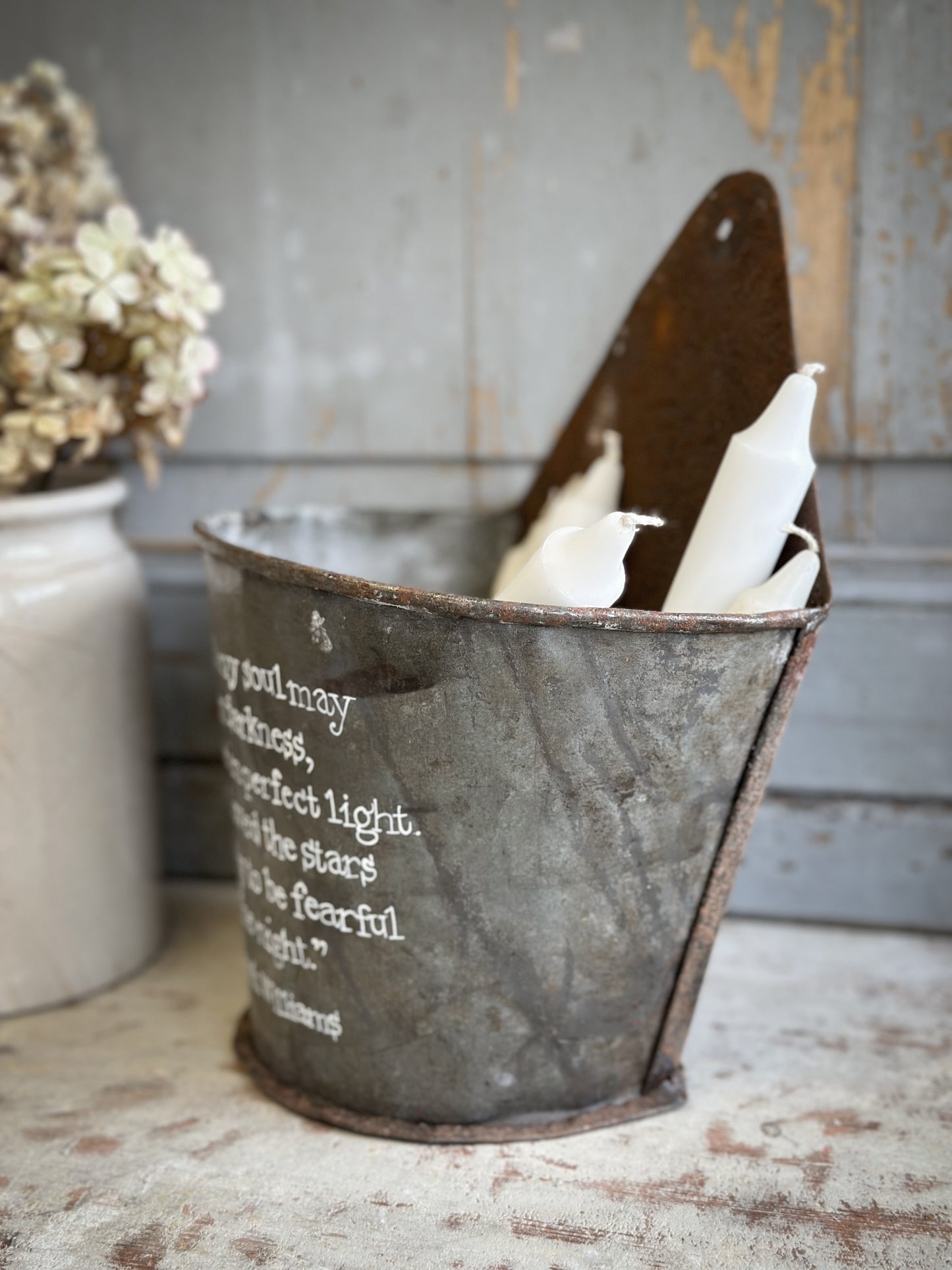 A Recycled Metal Candle Store With A Hand Painted Quote