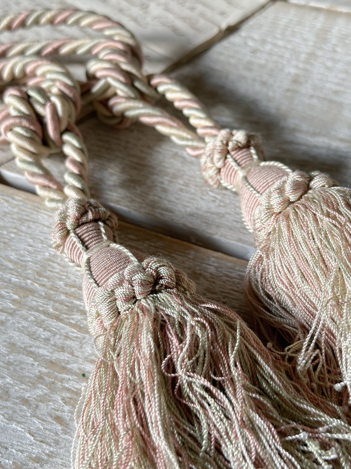 A pair of pretty vintage pastel pink, sage green and ivory curtain tie backs