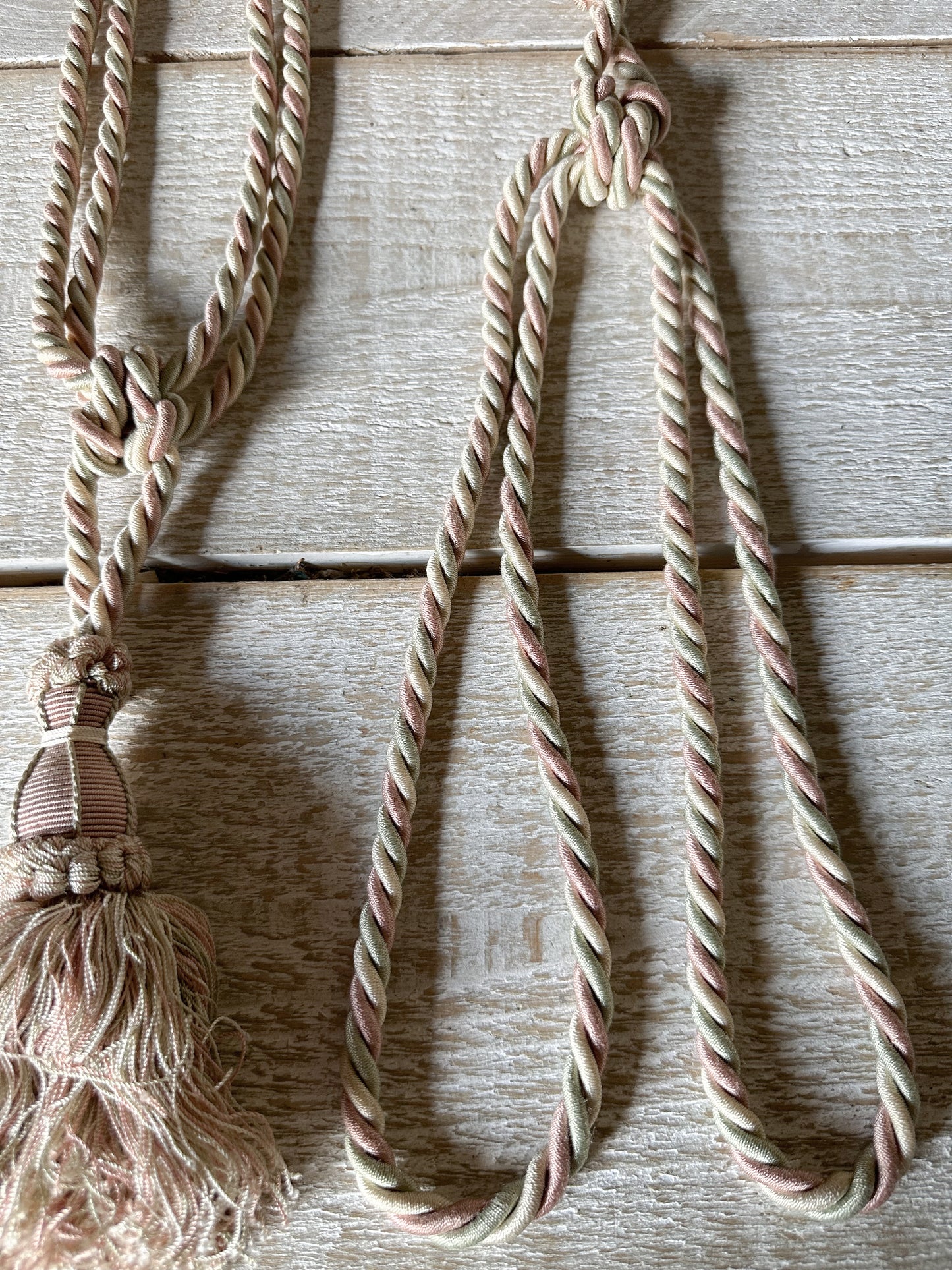 A pair of pretty vintage pastel pink, sage green and ivory curtain tie backs