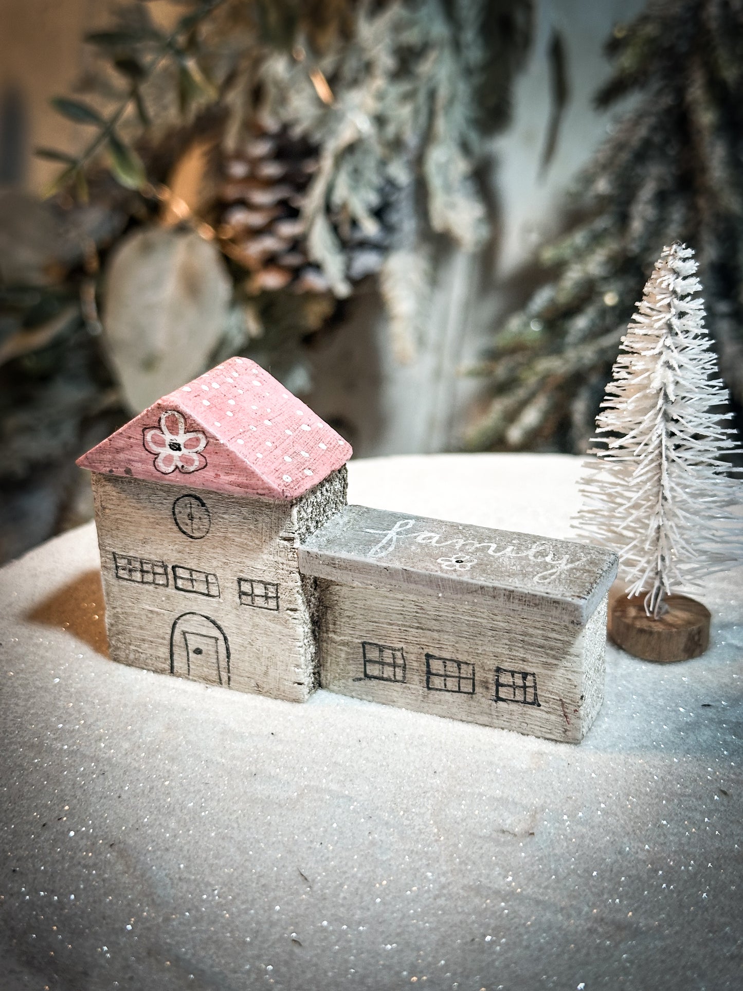 A pretty vintage German Erzgebirge Putz wooden village house painted with a Christmas quote