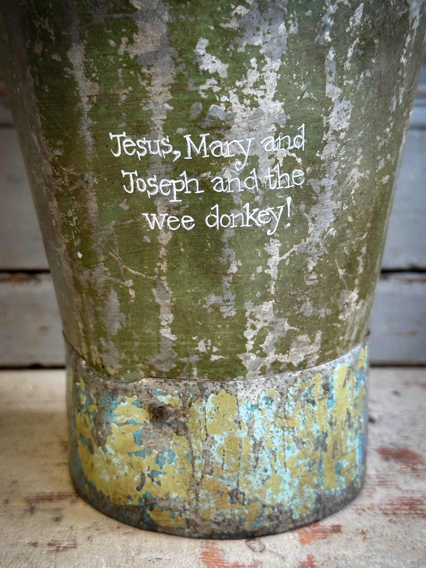 A Recycled Metal Mini Christmas Tree Bucket With A Hand Painted Quote