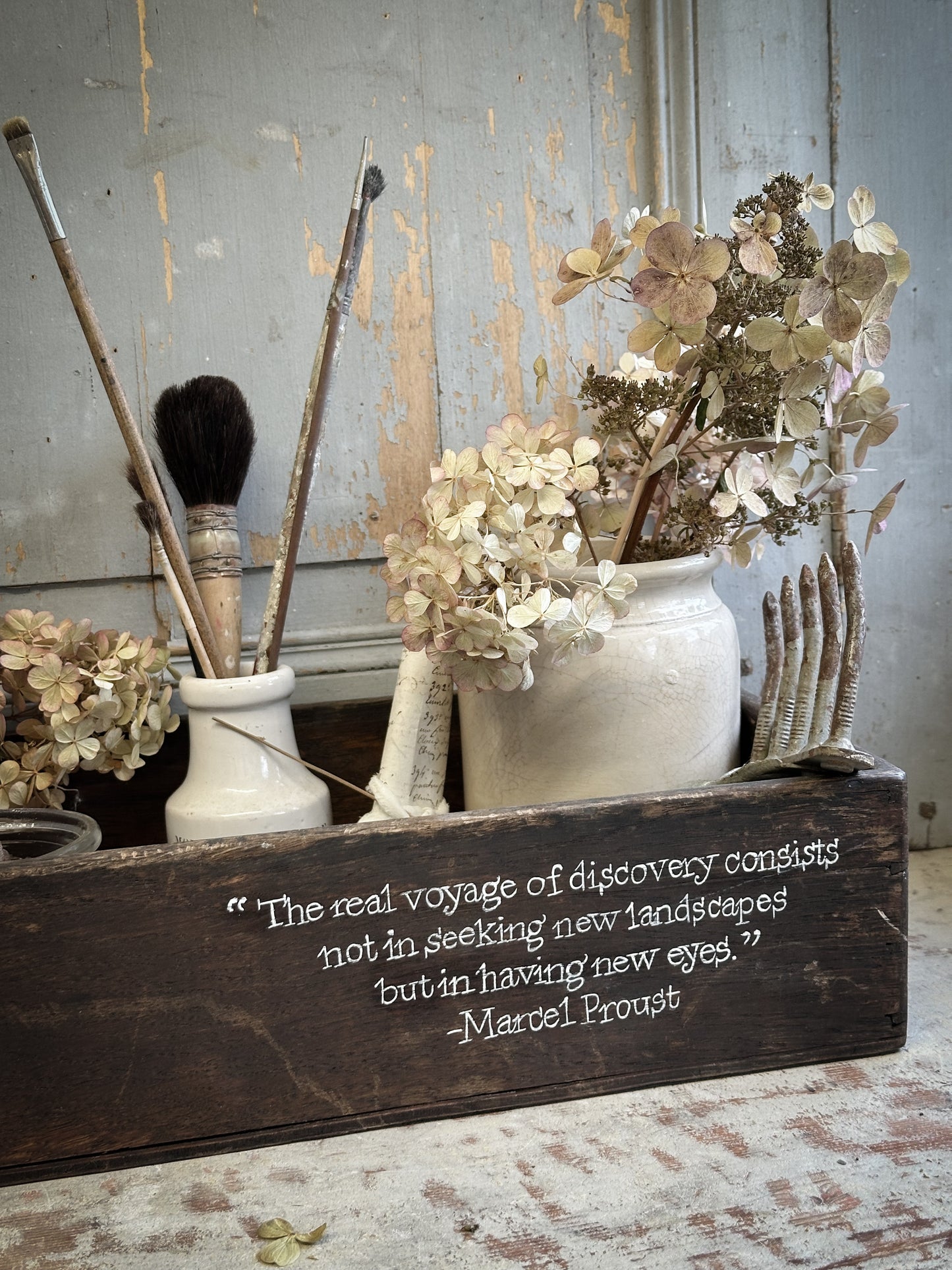 A Vintage Wooden Crate With Hand Painted Quote