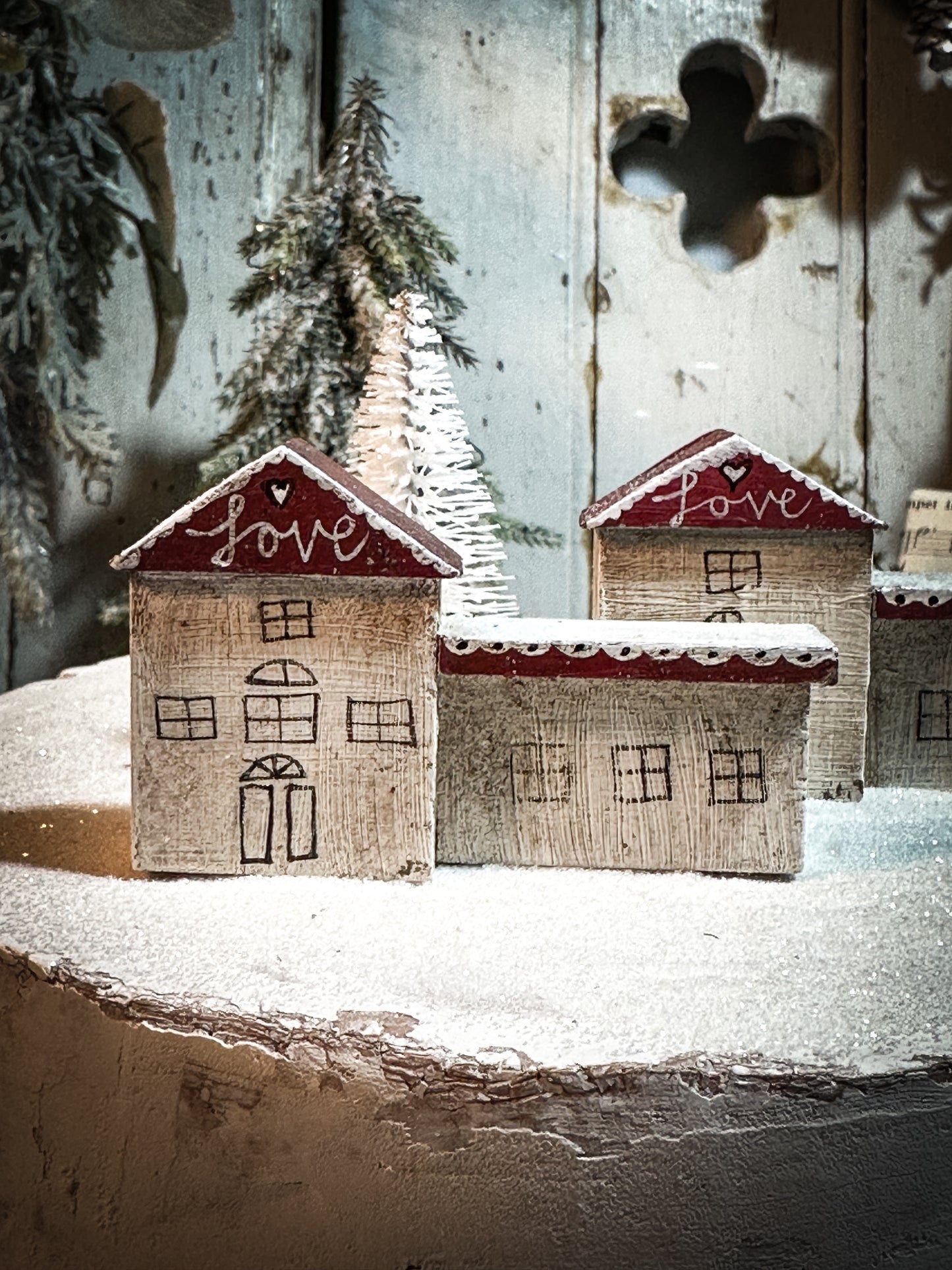 A pretty vintage German Erzgebirge Putz wooden village house painted with a Christmas quote