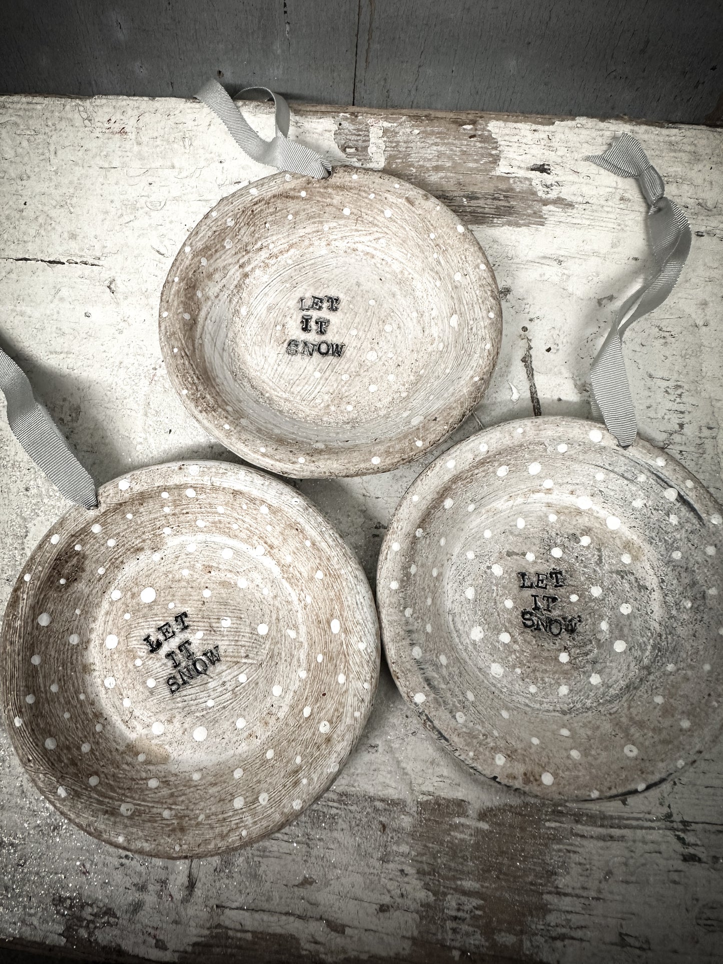 A Reworked French Patisserie Tin Christmas Decoration Stamped and Painted “Let It Snow”