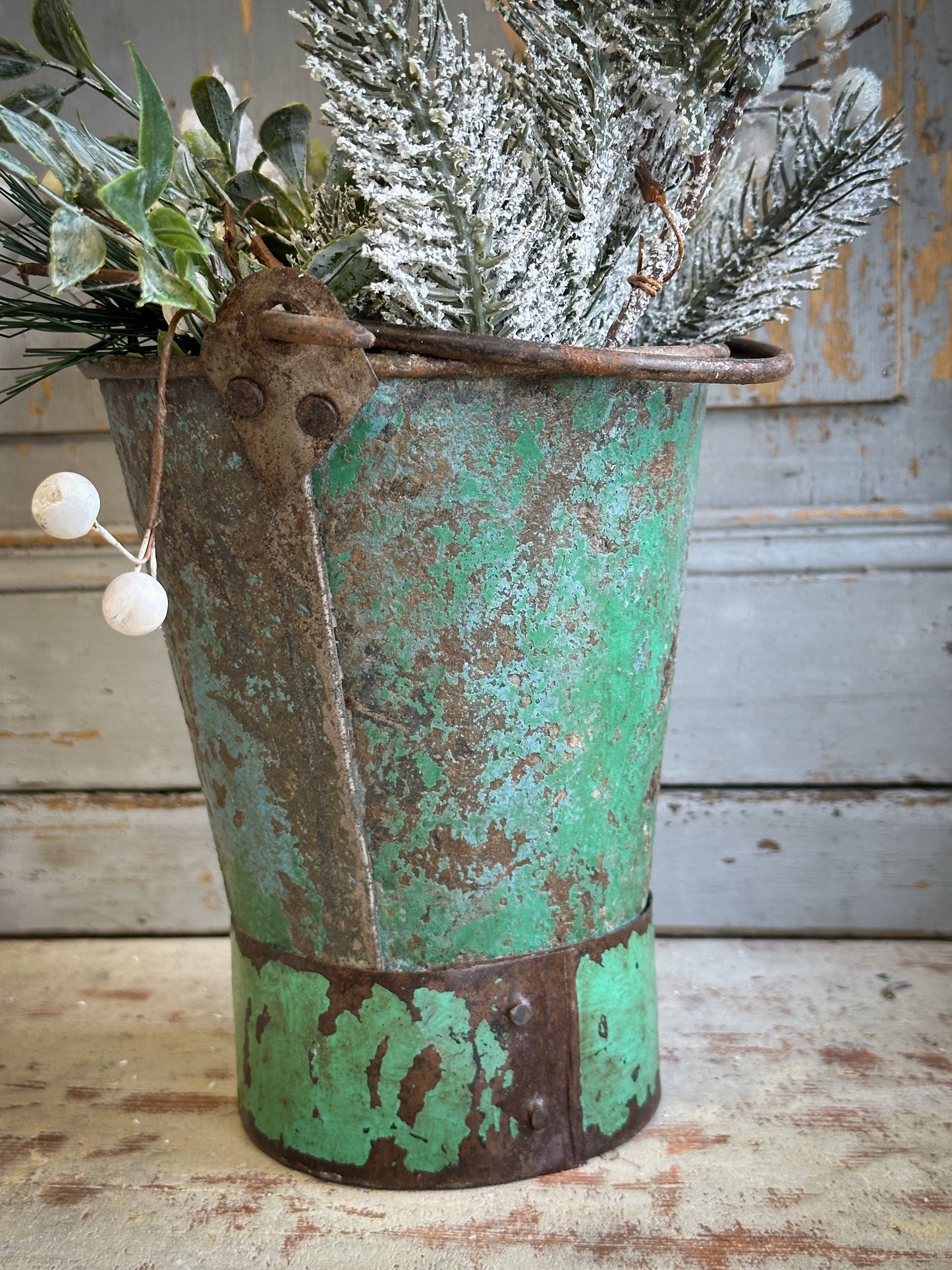 A Recycled Metal Mini Christmas Tree Bucket With A Hand Painted Quote