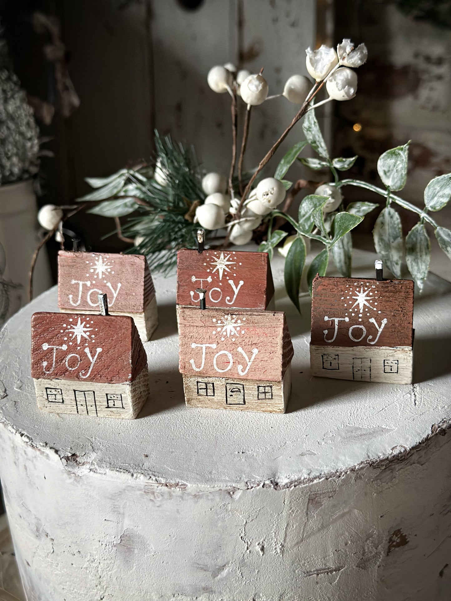 A pretty vintage German Erzgebirge Putz wooden village house painted with a Christmas quote