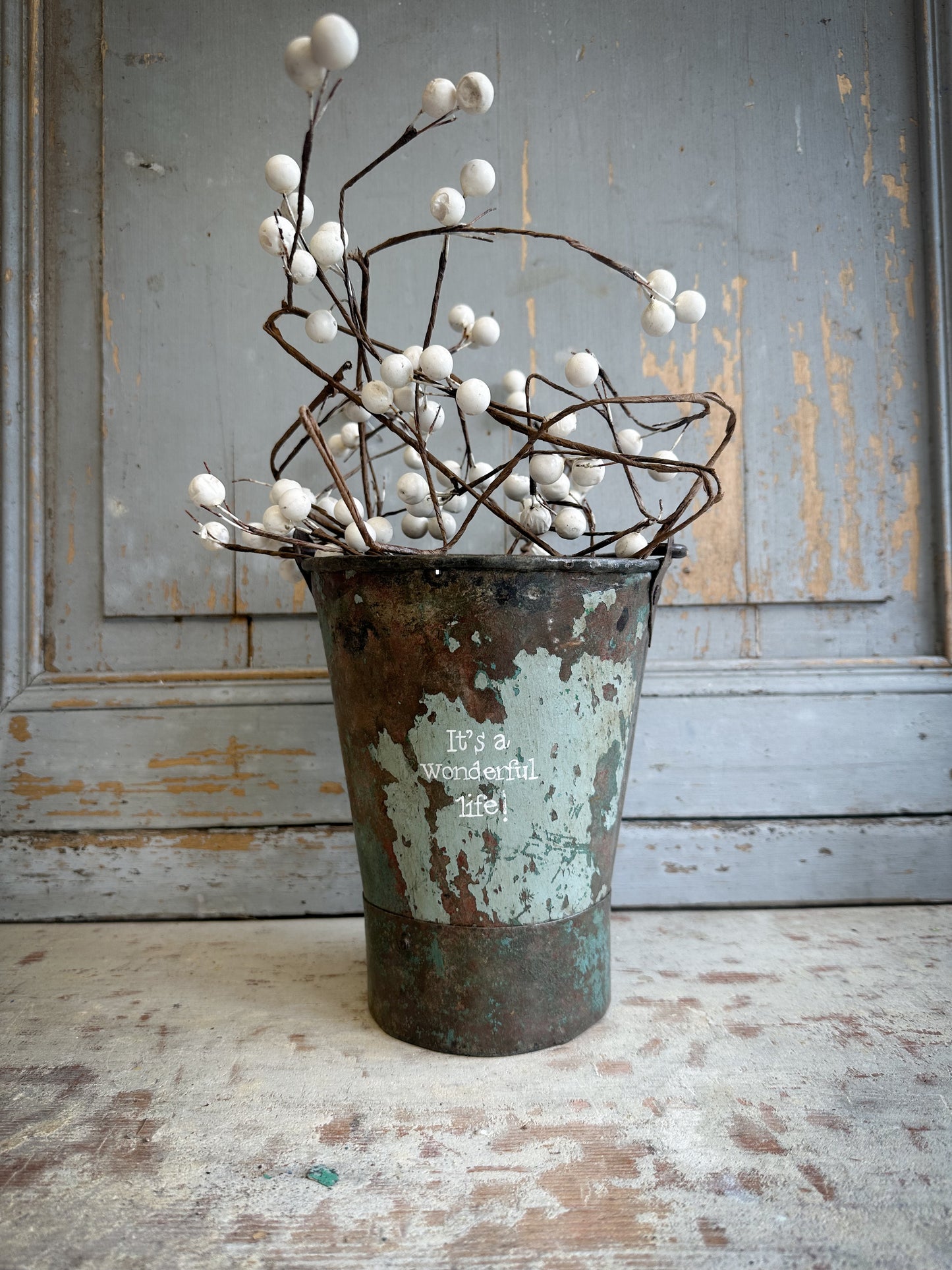 A Recycled Metal Mini Christmas Tree Bucket With A Hand Painted Quote