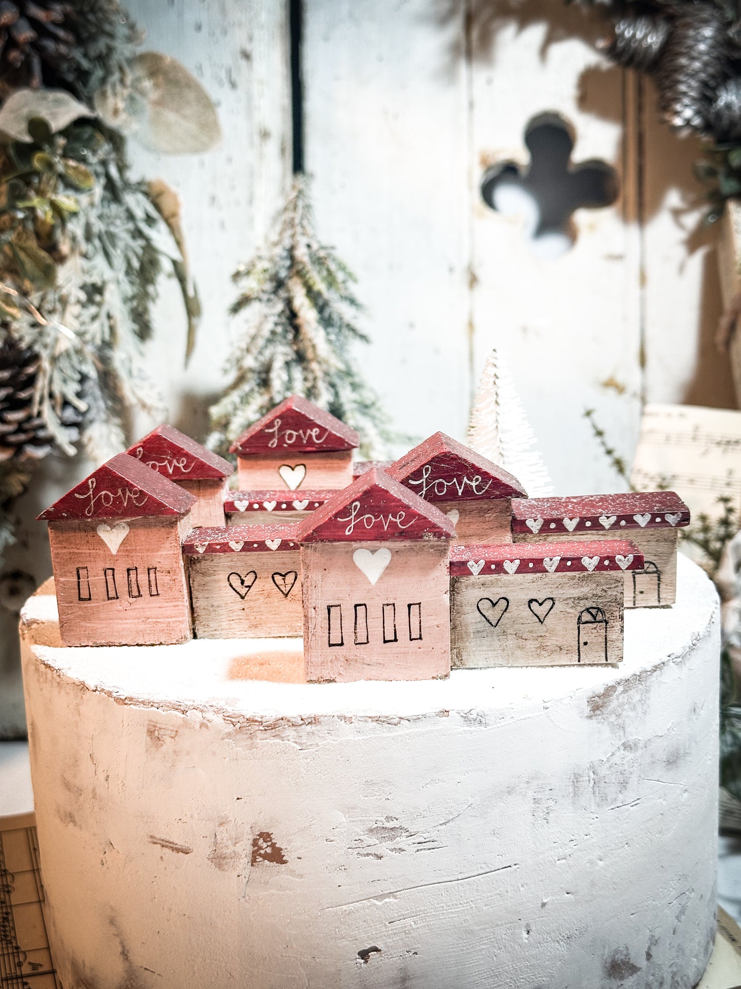 A pretty vintage German Erzgebirge Putz wooden village house painted with a Christmas quote