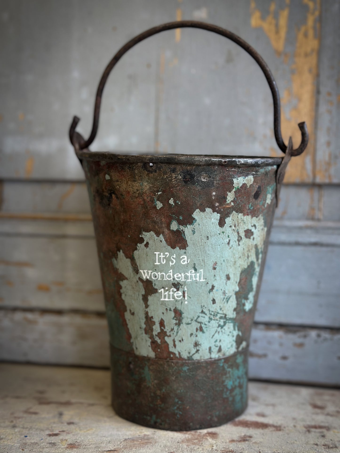 A Recycled Metal Mini Christmas Tree Bucket With A Hand Painted Quote