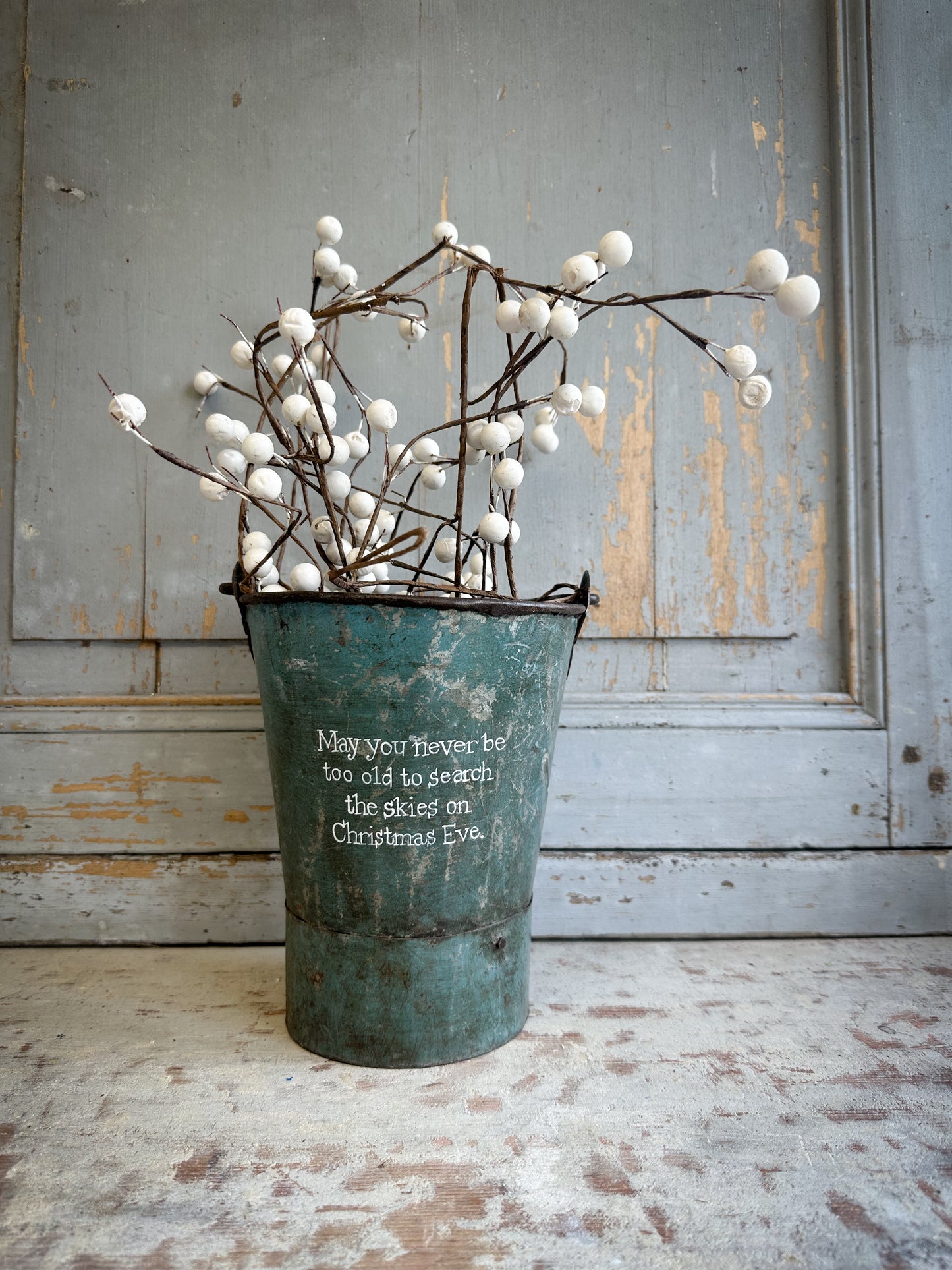 A Recycled Metal Mini Christmas Tree Bucket With A Hand Painted Quote