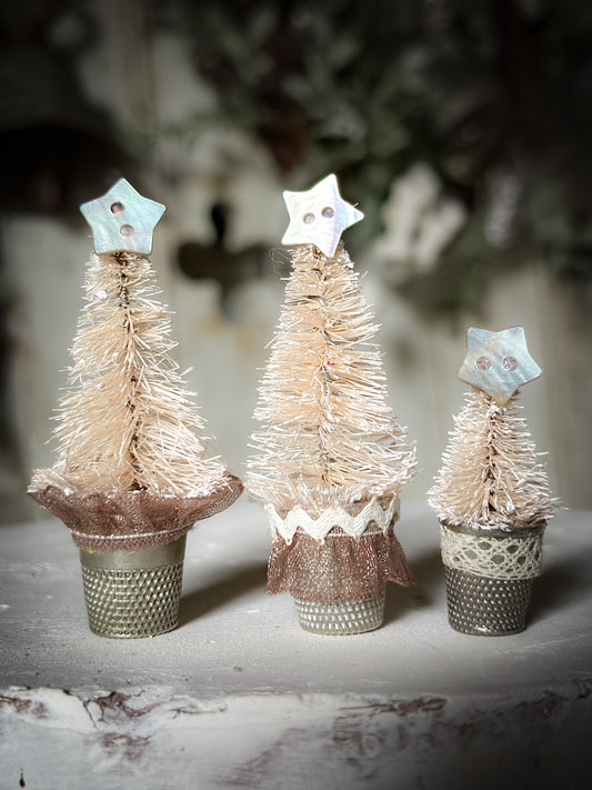 A set of three thimble Christmas trees