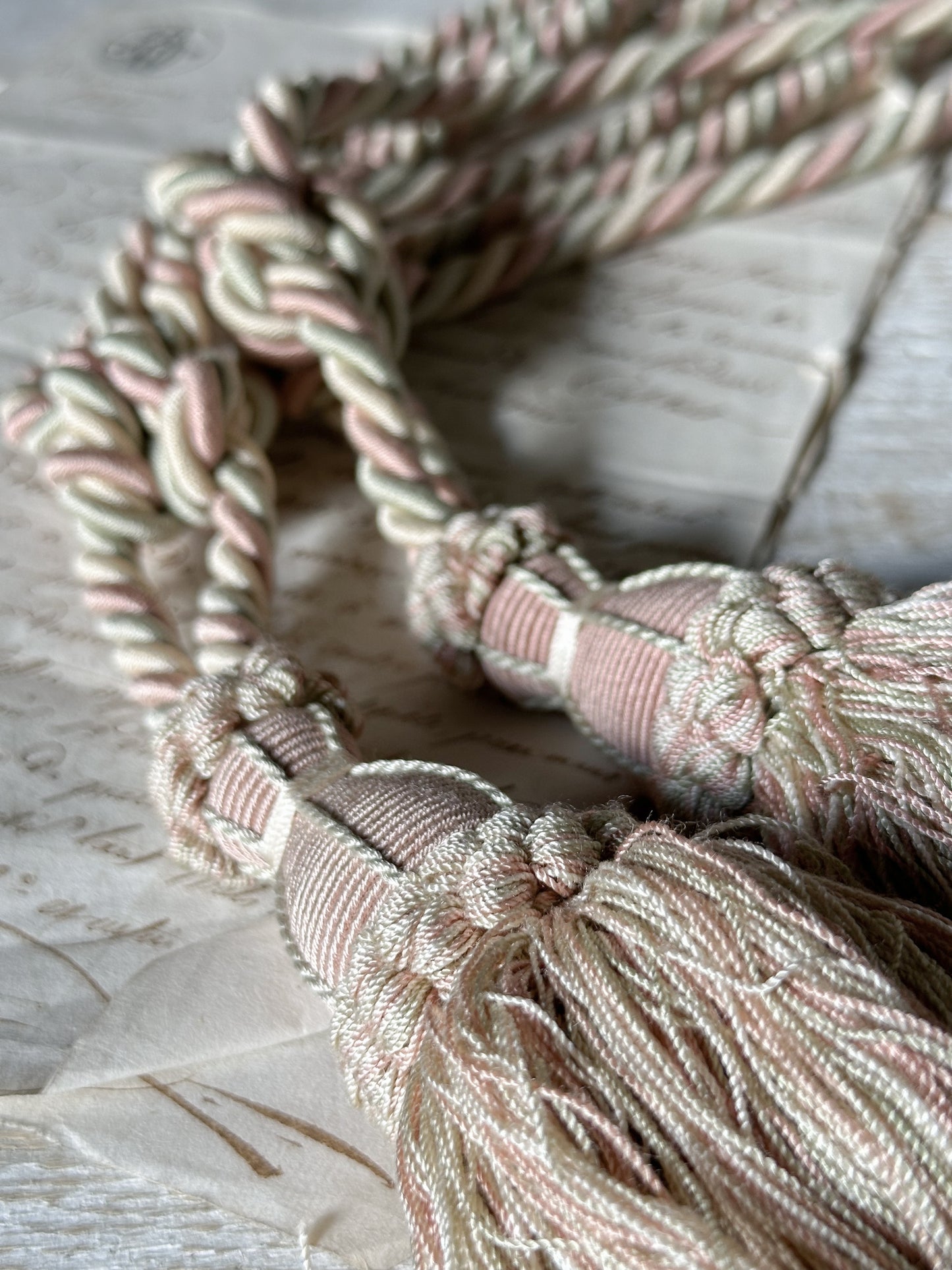 A pair of pretty vintage pastel pink, sage green and ivory curtain tie backs