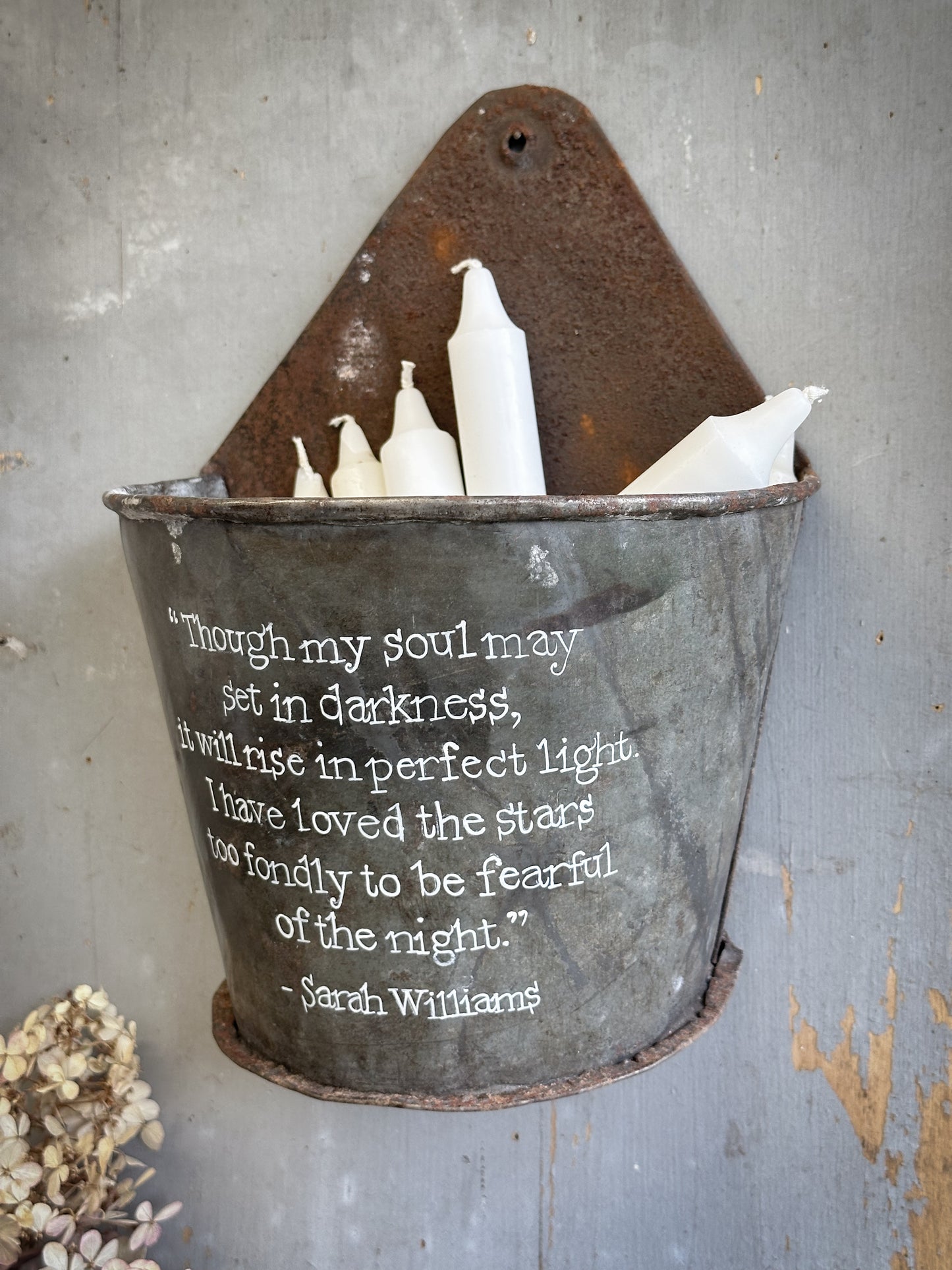A Recycled Metal Candle Store With A Hand Painted Quote