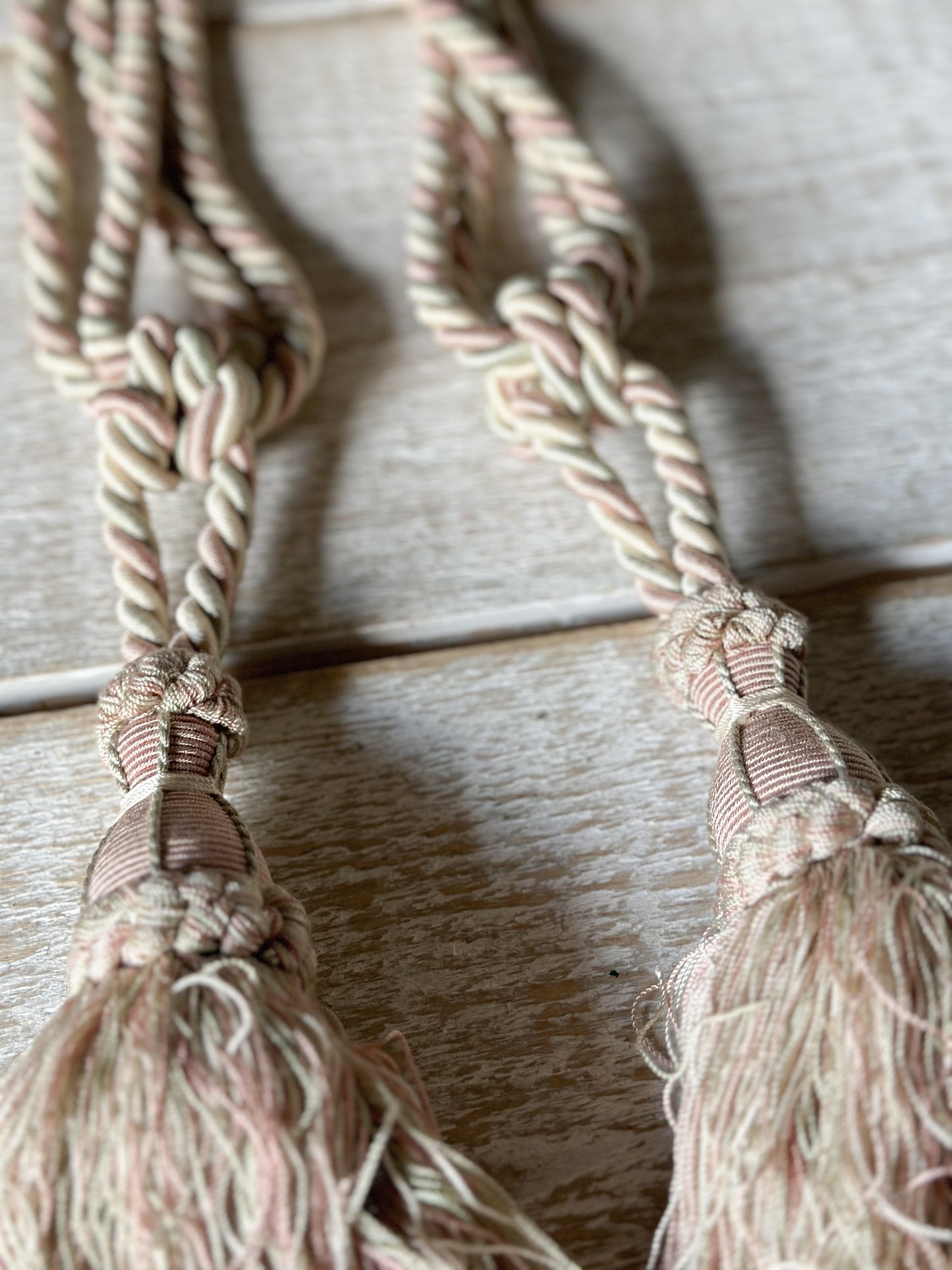 A pair of pretty vintage pastel pink, sage green and ivory curtain tie backs