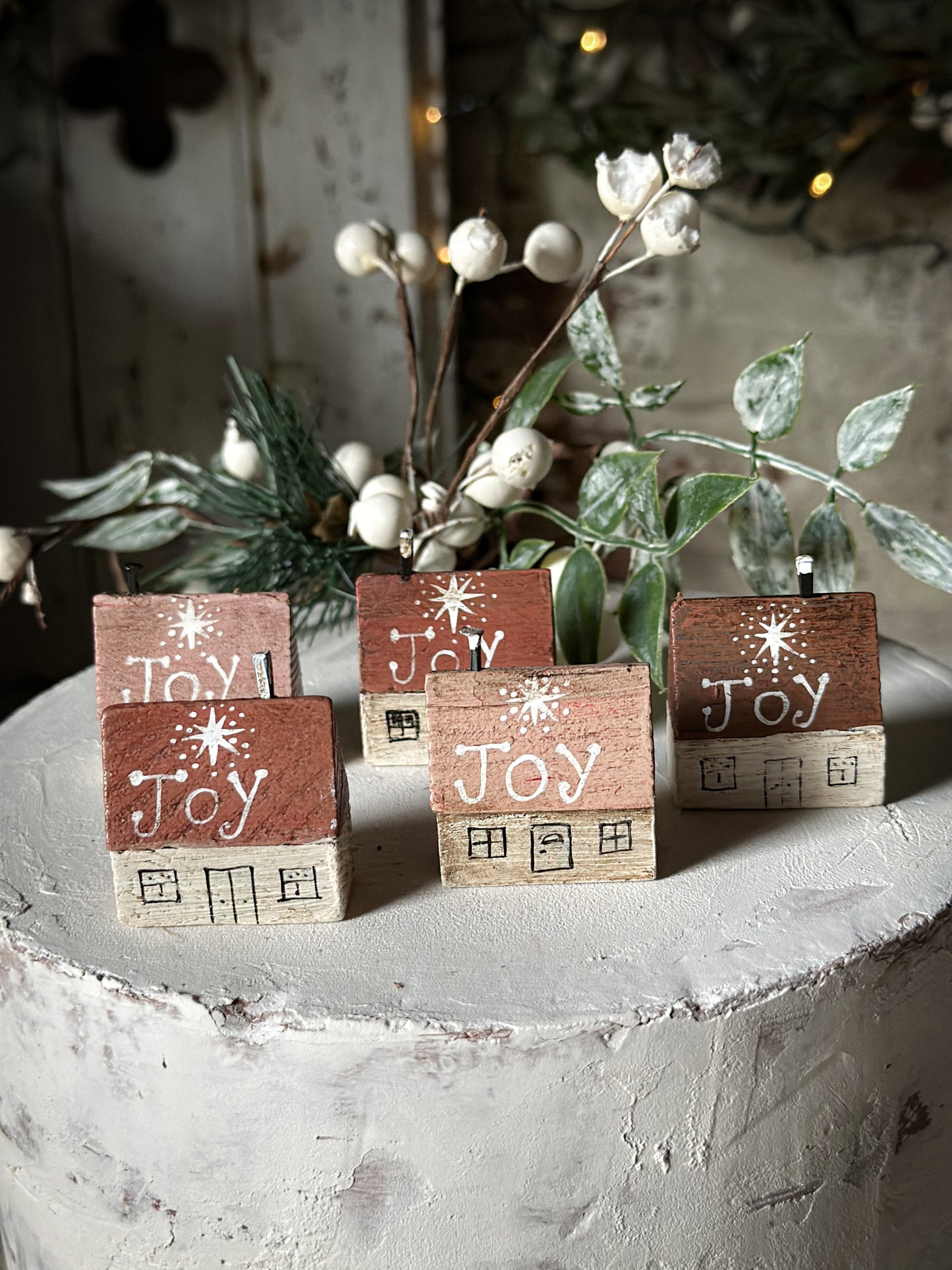 A pretty vintage German Erzgebirge Putz wooden village house painted with a Christmas quote