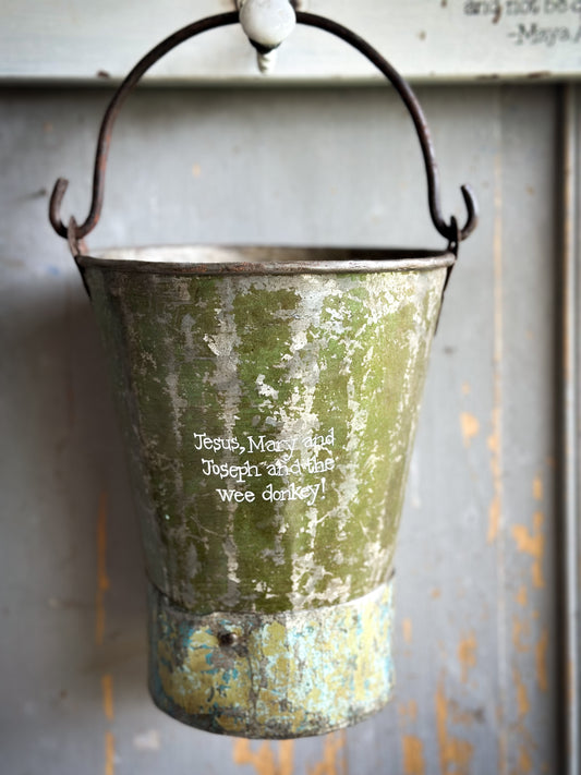 A Recycled Metal Mini Christmas Tree Bucket With A Hand Painted Quote