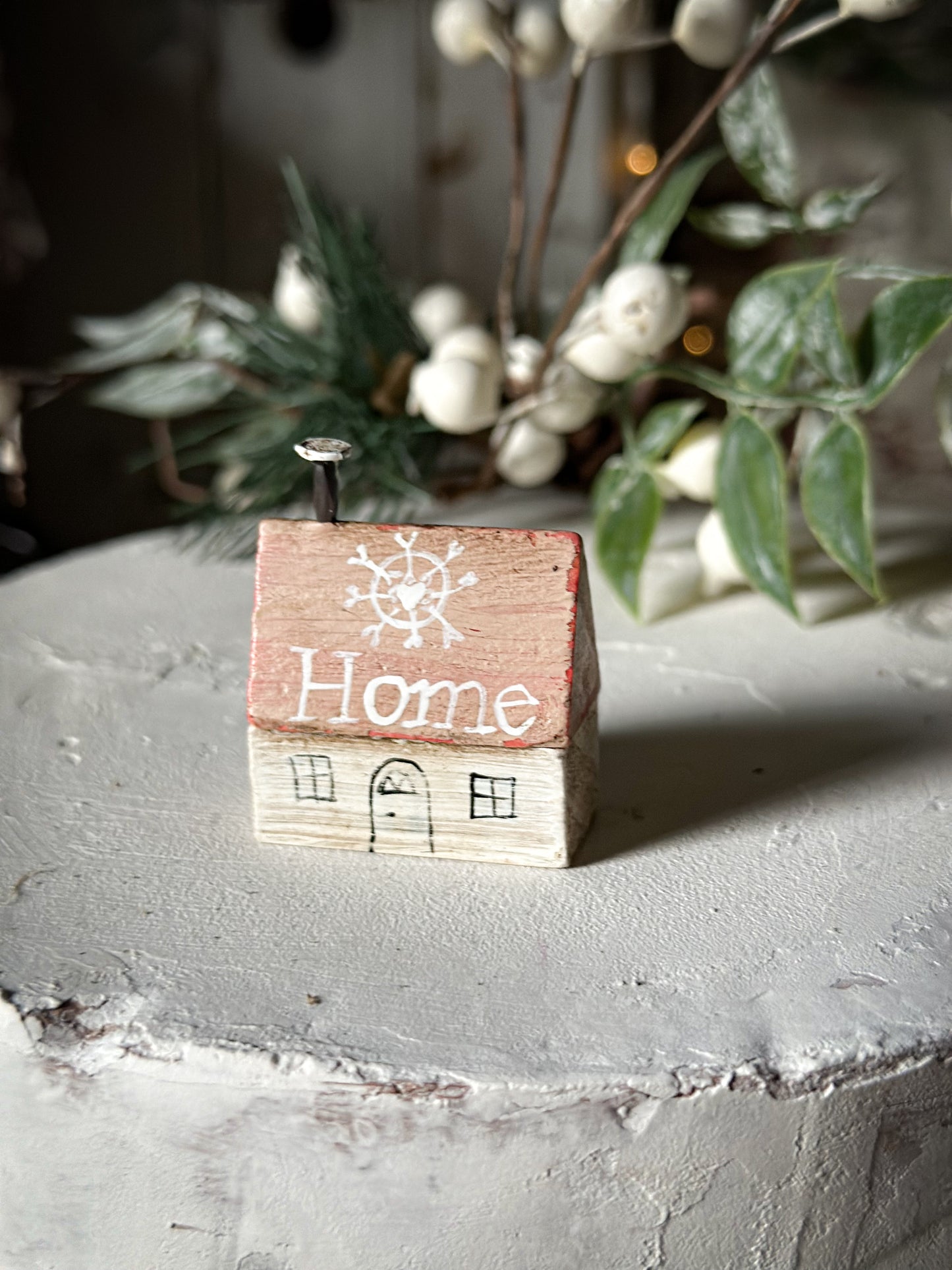 A pretty vintage German Erzgebirge Putz wooden village house painted with a Christmas quote