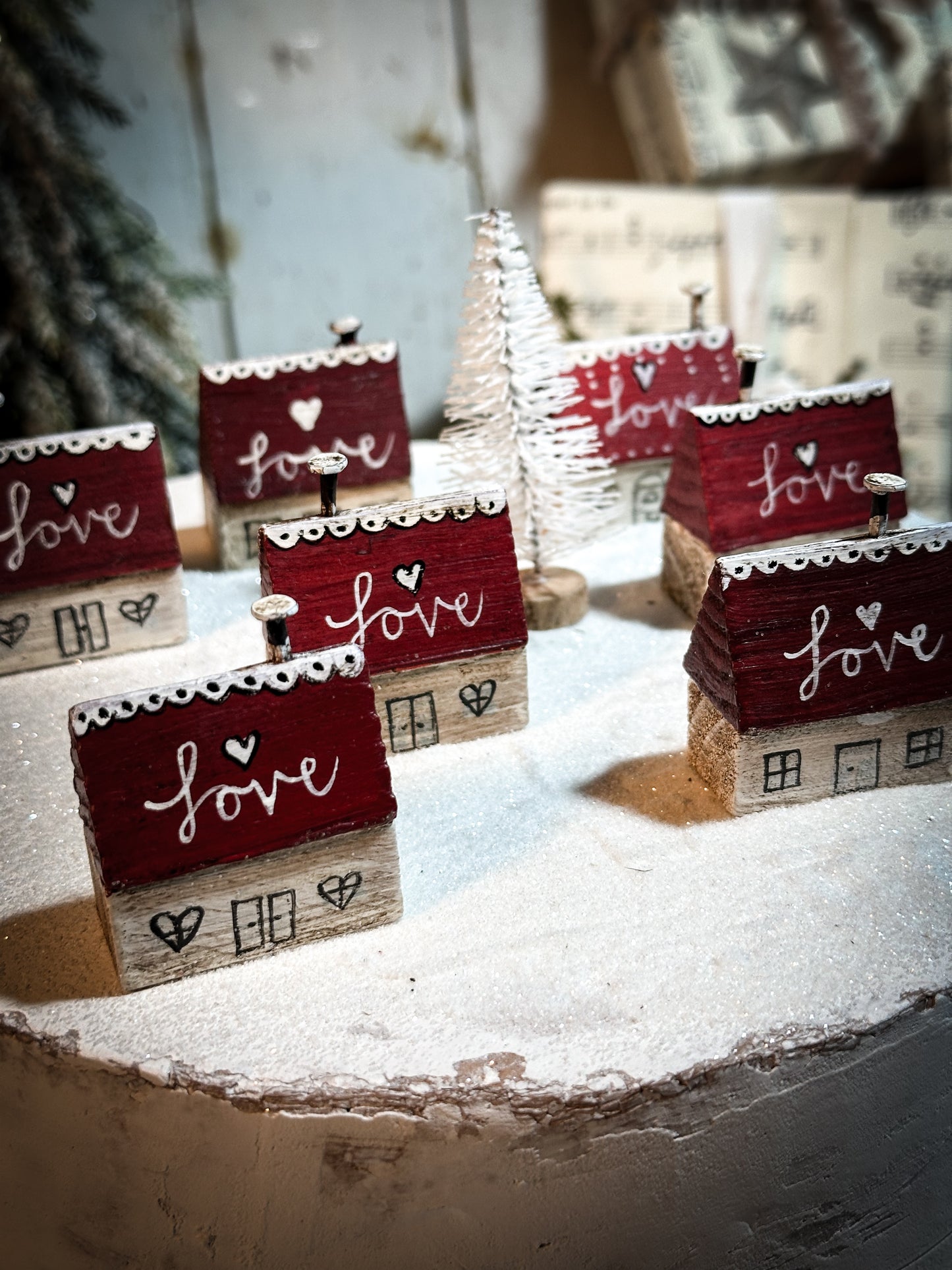 A pretty vintage German Erzgebirge Putz wooden village house painted with a Christmas quote