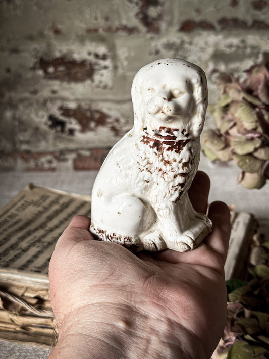 A miniature Staffordshire dog ornament