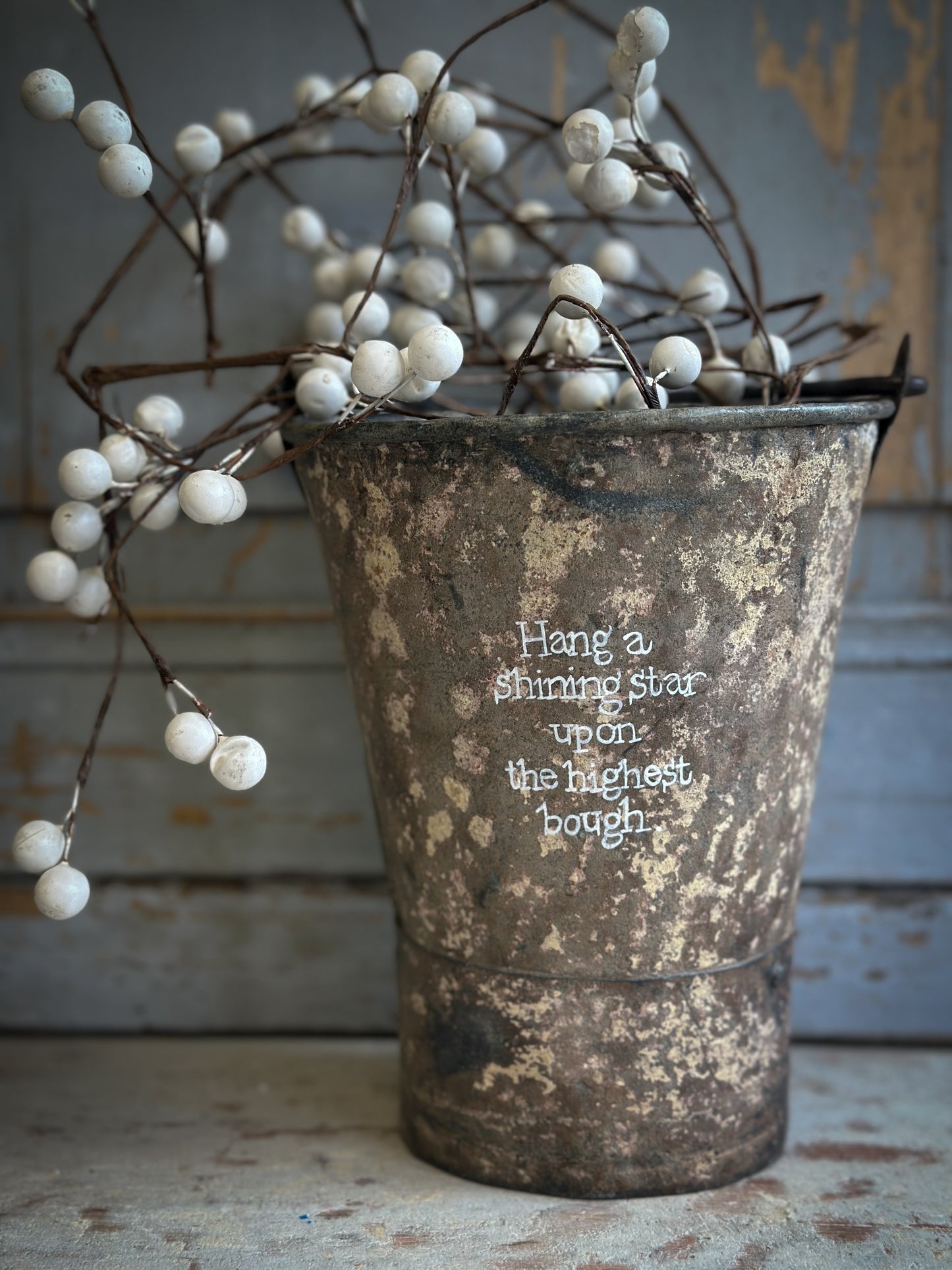 A Recycled Metal Mini Christmas Tree Bucket With A Hand Painted Quote