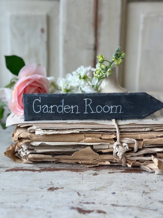 A small hand painted Victorian Welsh slate sign in lower case “Garden Room”