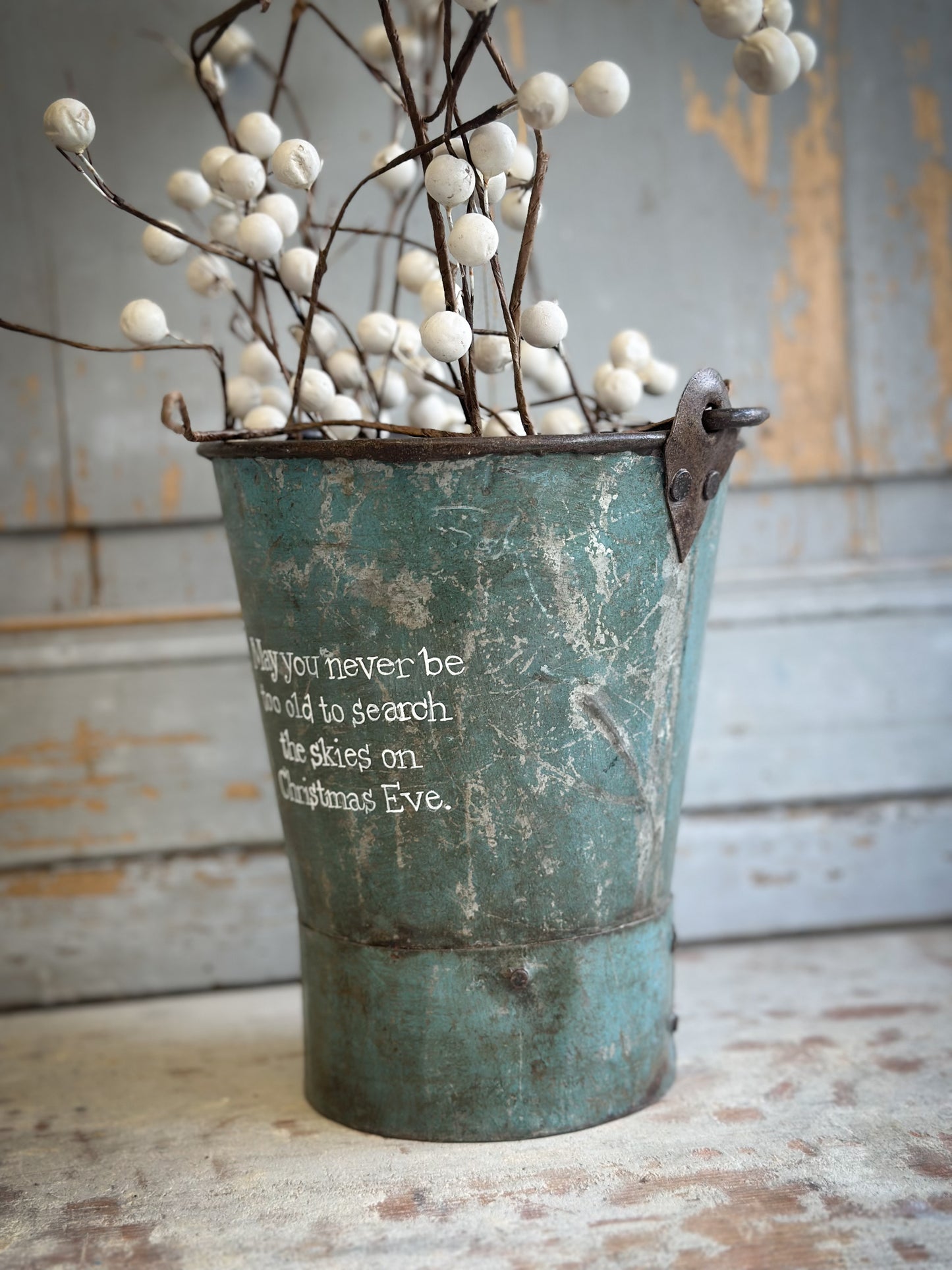 A Recycled Metal Mini Christmas Tree Bucket With A Hand Painted Quote