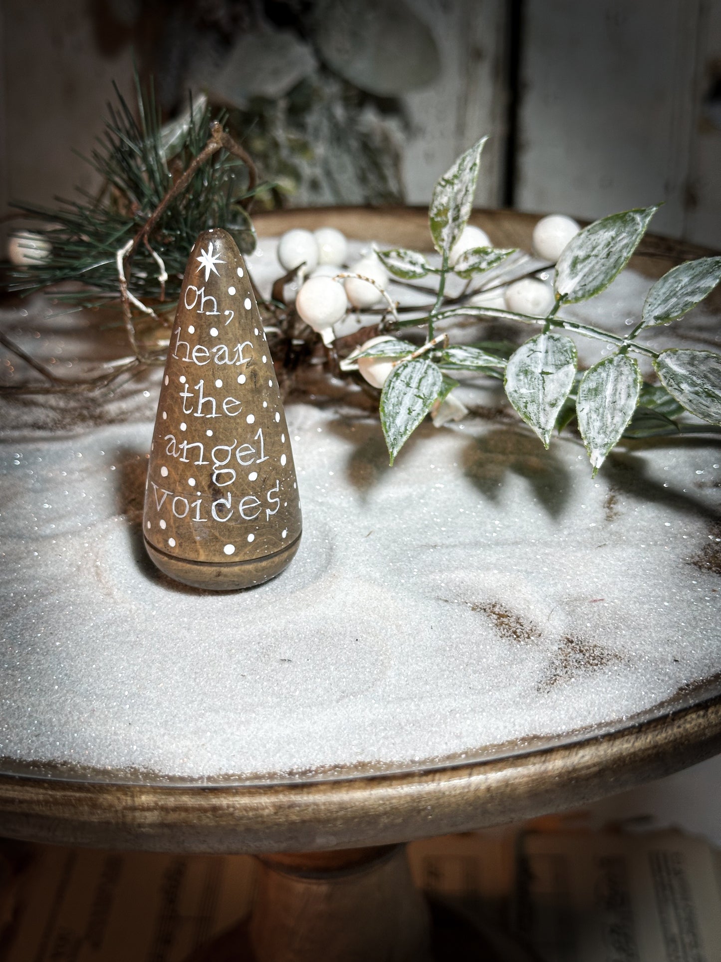 A hand painted quote on a lignum vitae wood plumber’s turnpin with a Christmas quote